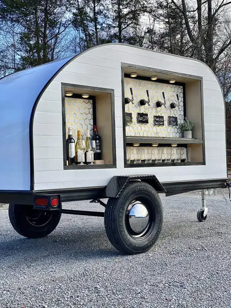 The Curated Pour’s white mobile tap trailer