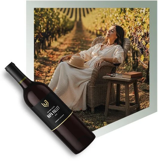 A woman relaxing in a wicker chair outdoors in a vineyard setting at sunset, with a straw hat on her lap and a book on a small table beside her, with a bottle of Napa Valley wine and a photo of the woman in the vineyard collage.