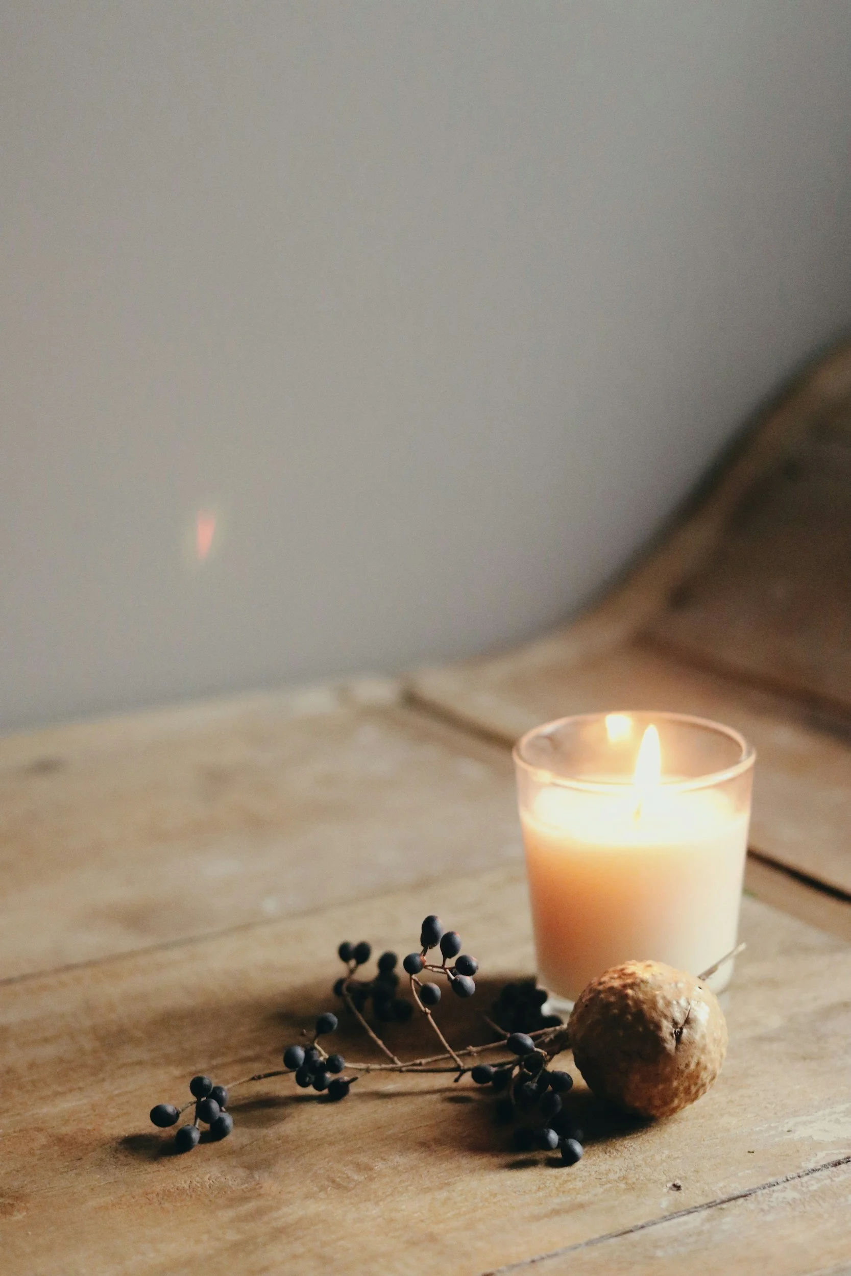 Candle and dried flowers on a wooden table