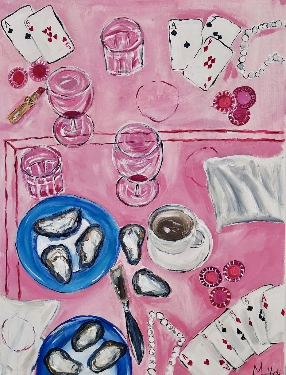 A pink table is set with cards, poker chips, oysters on blue plates, a knife, a cup of coffee, glasses, and pearl necklaces, suggesting a casual card game or gathering.