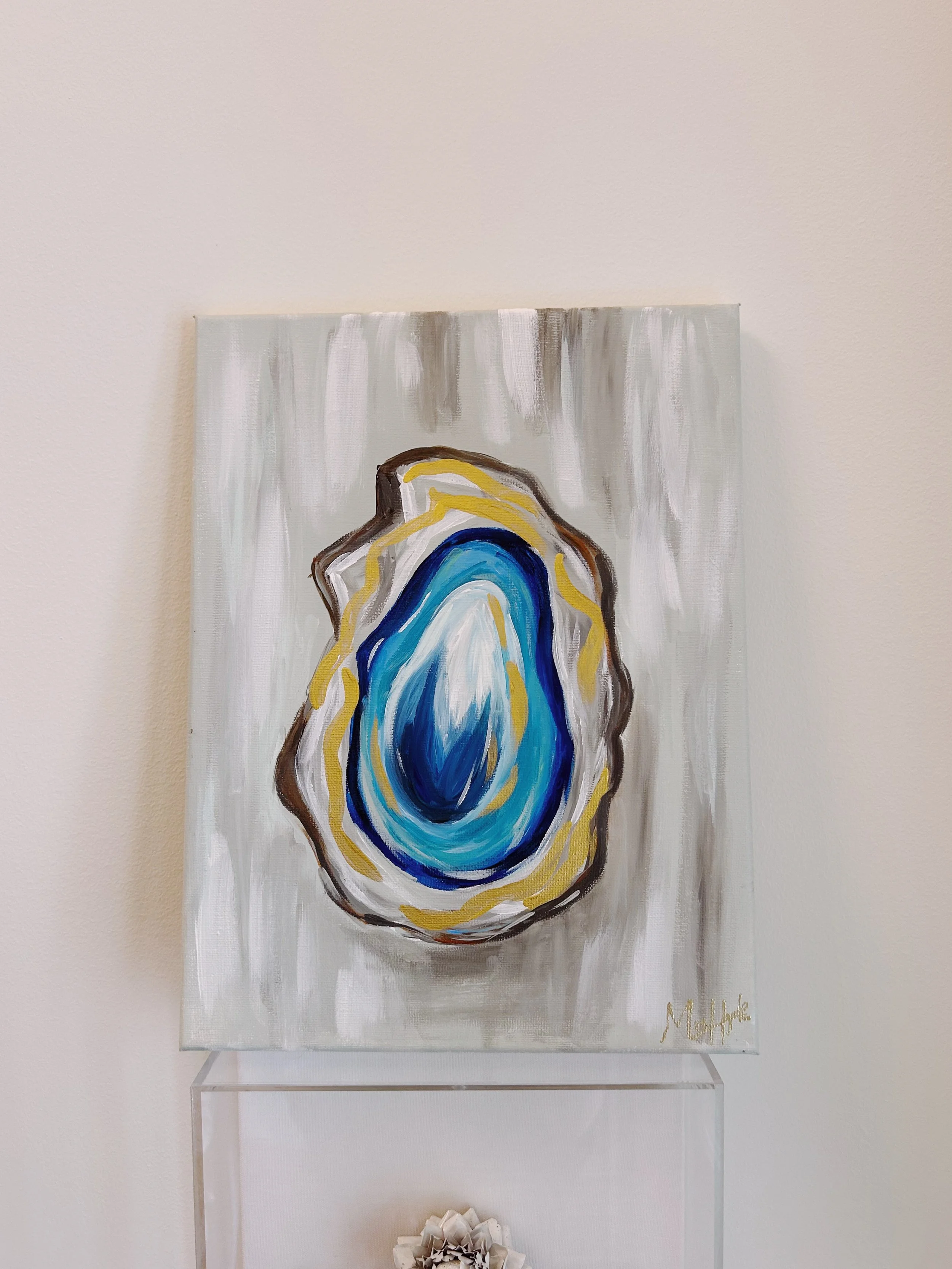An abstract painting of a blue, white, and yellow oyster shell on a white and gray background.