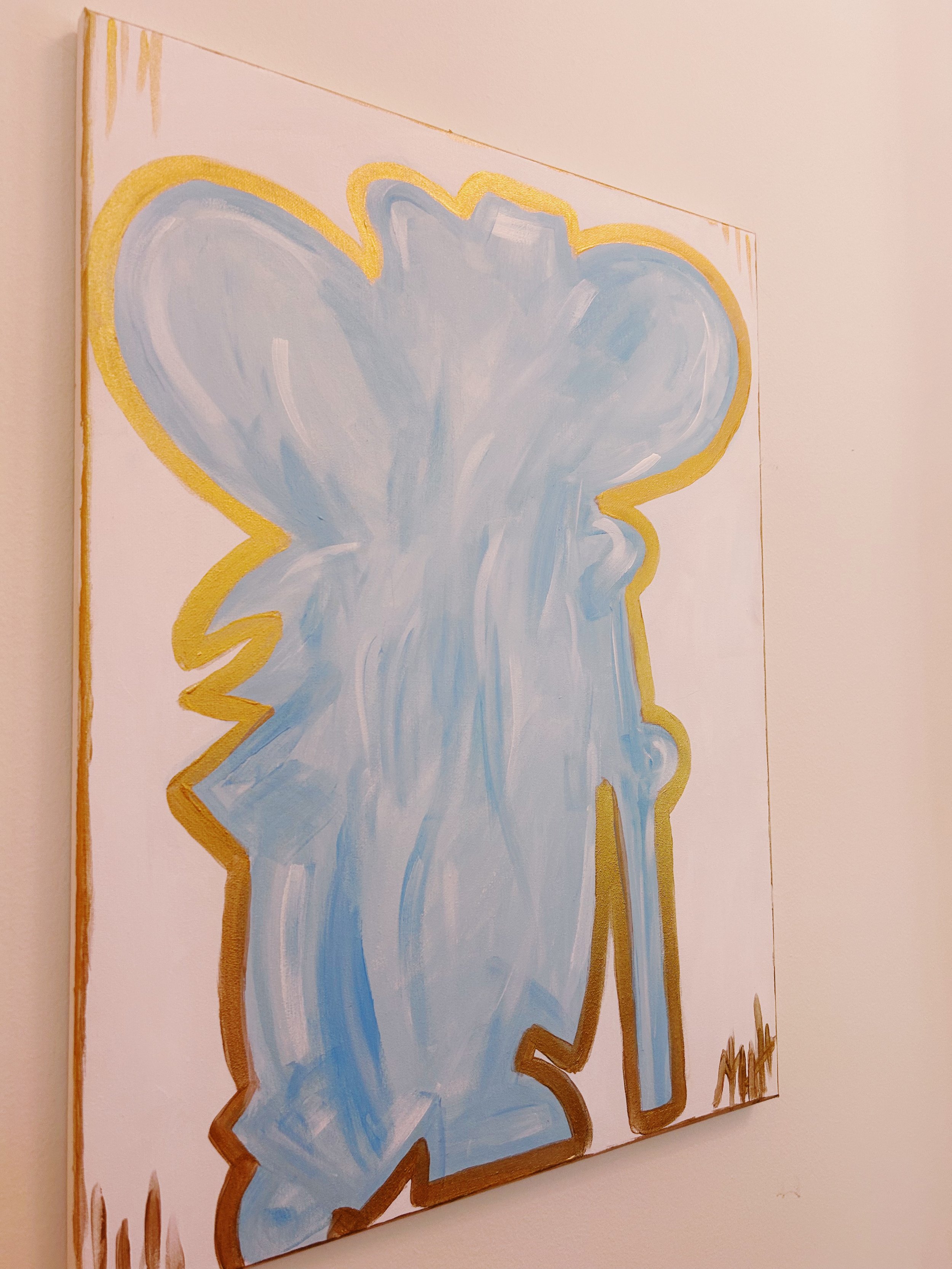 A painting of a blue flower with a yellow outline on a white canvas.