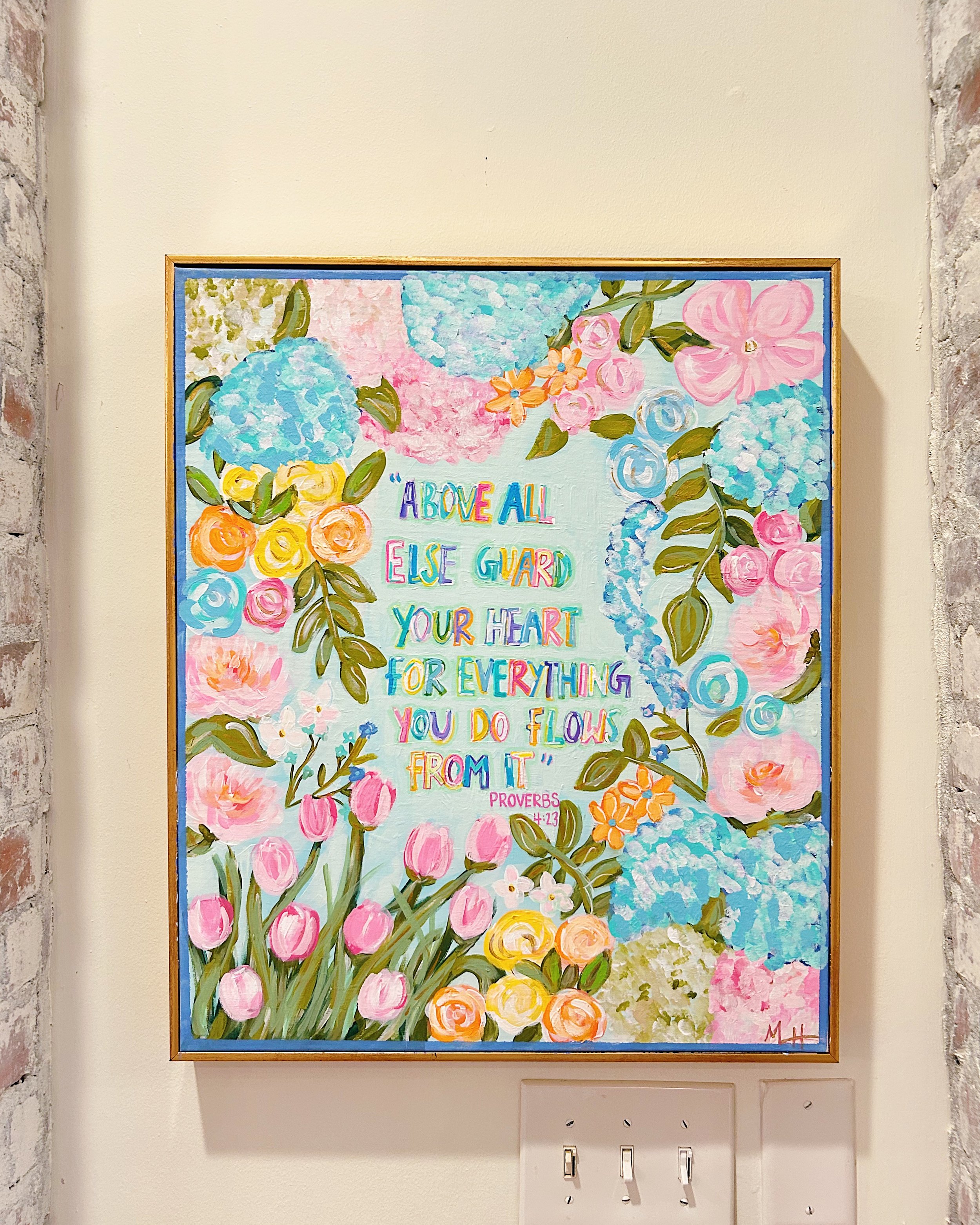 Colorful floral painting with a quote from Proverbs 4:23 about guarding your heart, with pink, blue, yellow, and green flowers and leaves around the text.