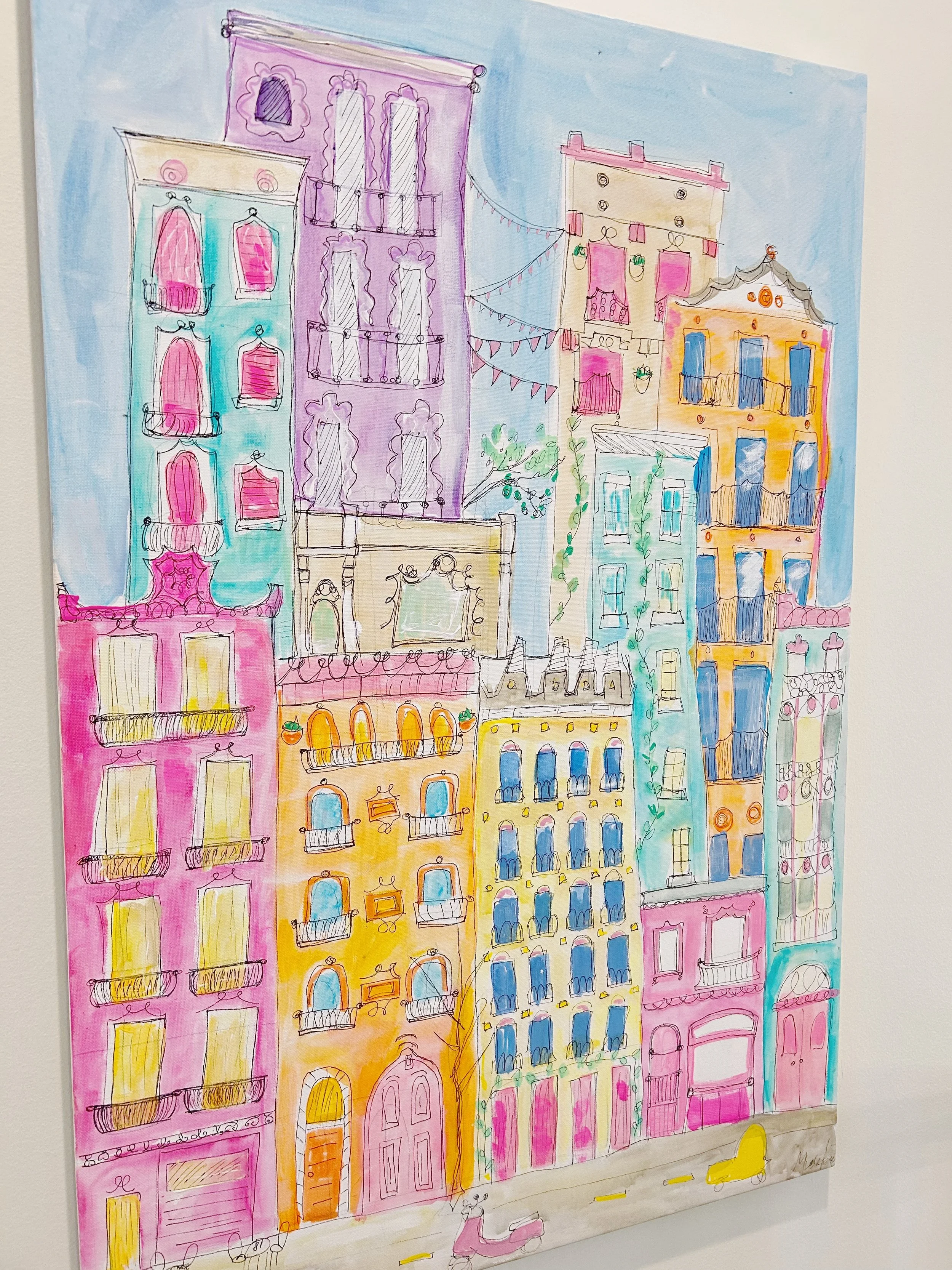 Colorful watercolor illustration of tall city buildings with balconies, windows, and decorative details in pink, yellow, blue, purple, and gray, with a street scene at the bottom.