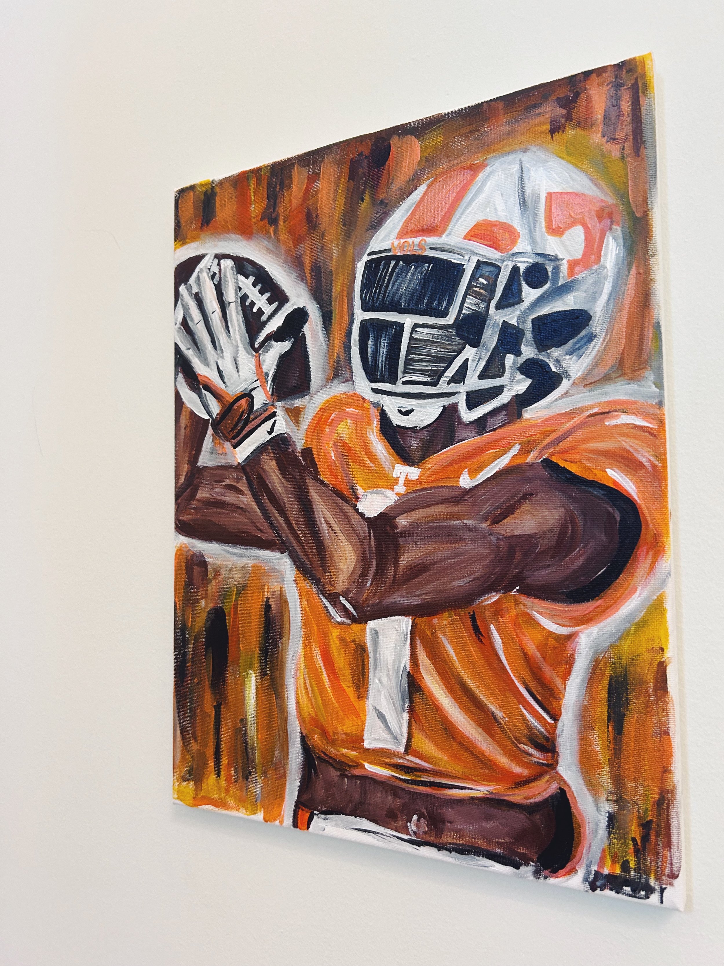 A painting of a football player in an orange uniform with a helmet featuring navy blue and orange accents, holding a football and wearing a glove.