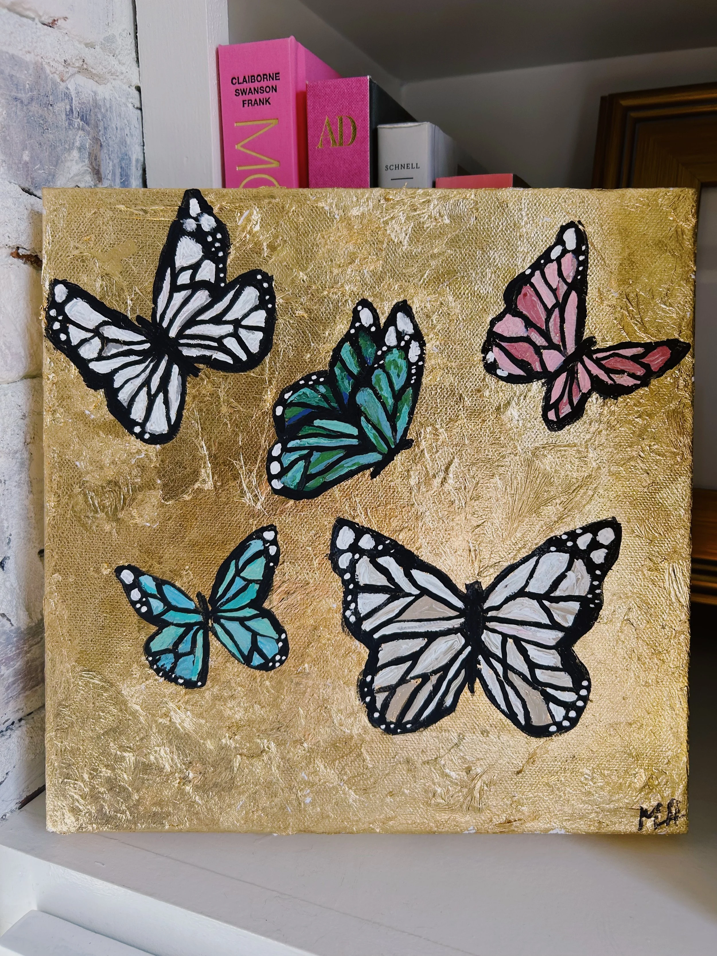 Six colorful butterflies on a gold textured background.