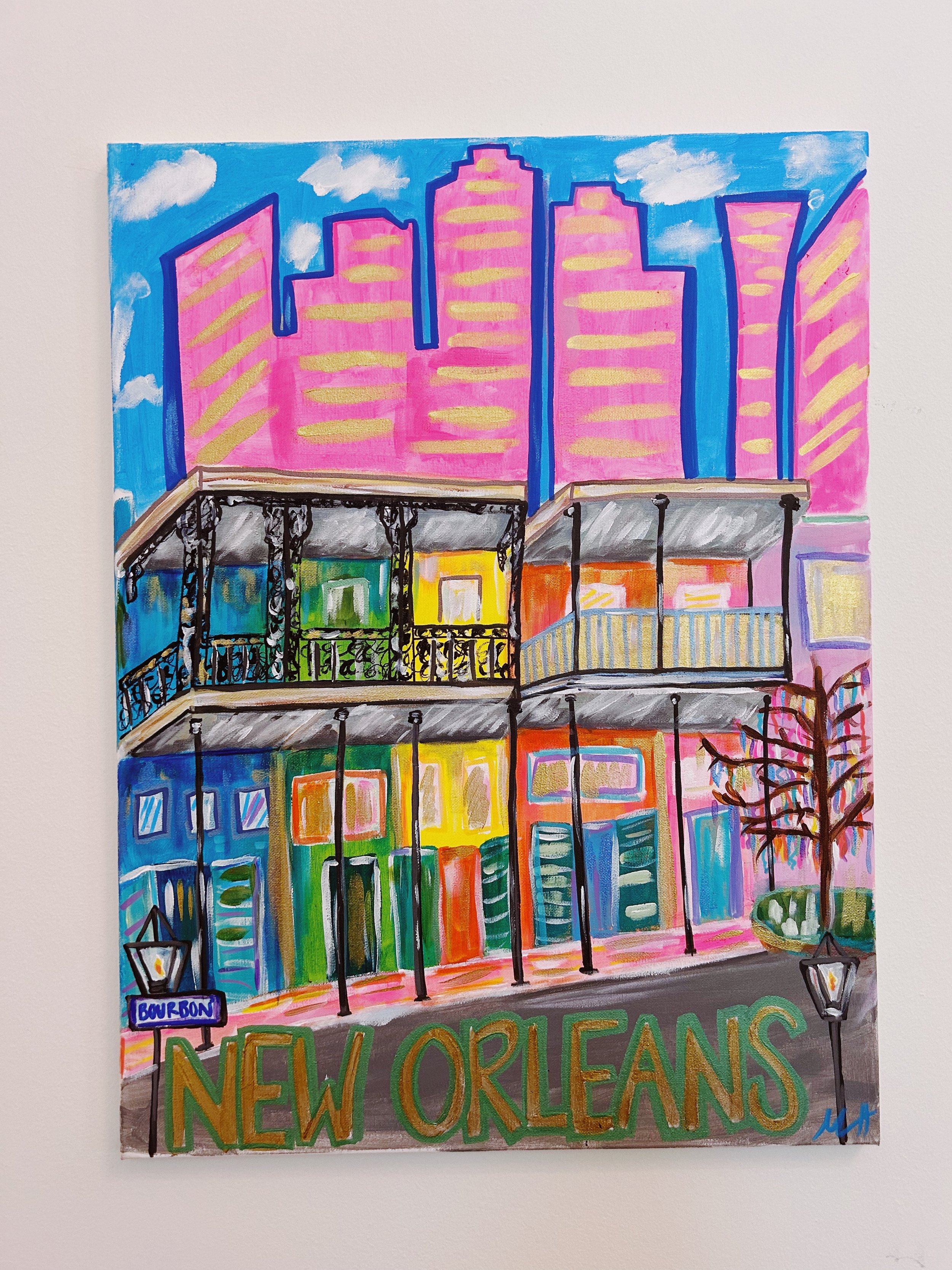 Colorful painting of a New Orleans street scene with a building featuring two balconies, street lamps, a tree, and a skyline of pink skyscrapers in the background. The words "New Orleans" are painted at the bottom.
