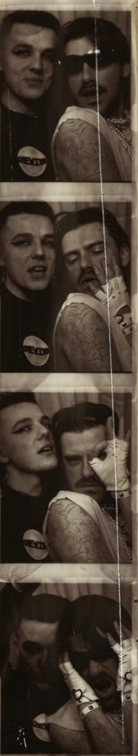 A black and white photo booth strip featuring two young adults, making various expressive faces and poses, with one man wearing sunglasses and a sleeveless shirt.