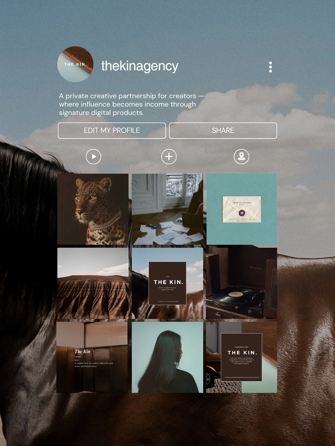 Screenshot of a social media profile named 'thekinagency' with a blue sky and clouds background. The profile description mentions a private partnership for creators. There are profile options like 'Edit My Profile' and 'Share,' and a grid of images including a leopard, a woman, a turntable, and abstract art.