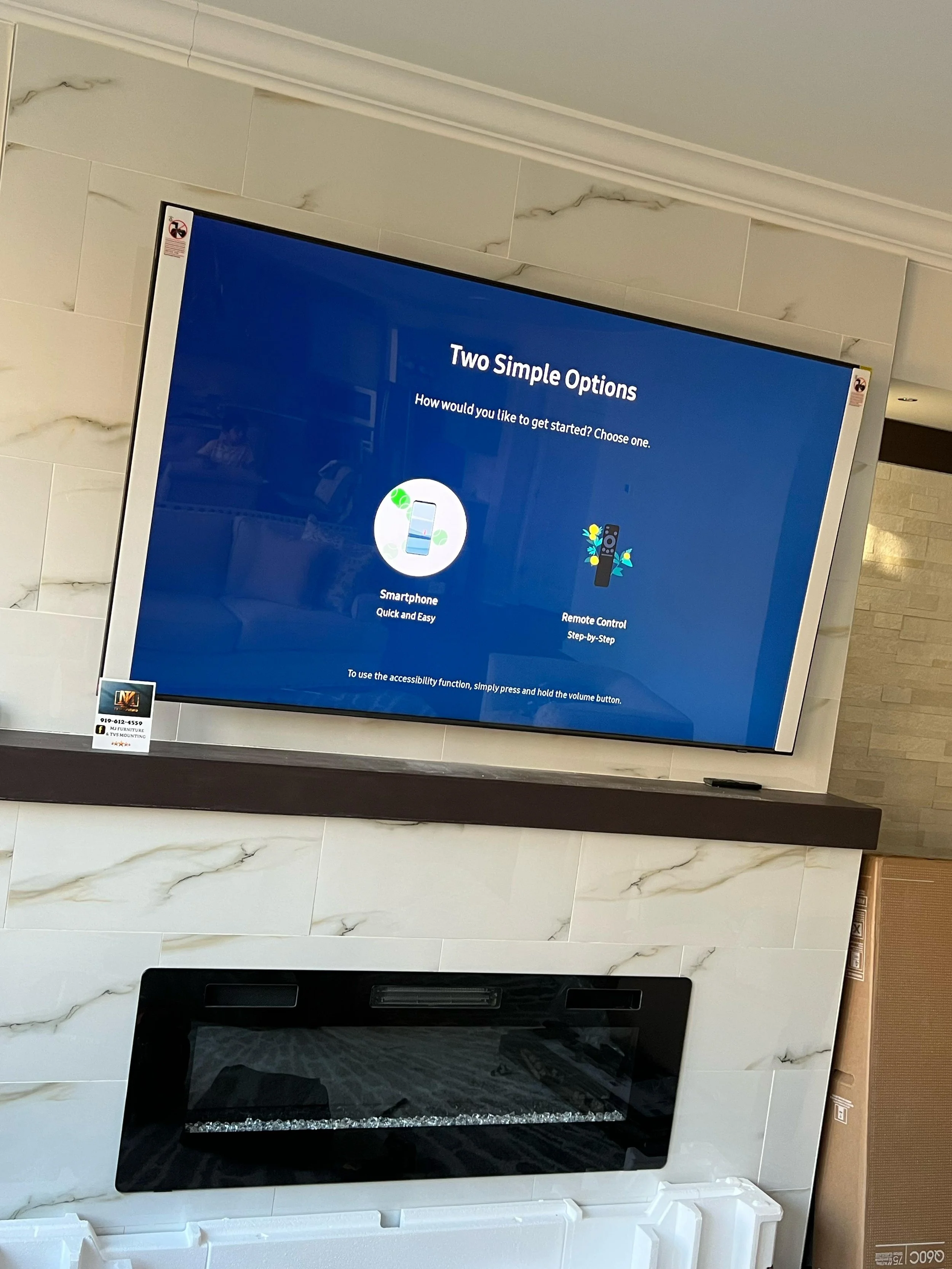 Digital screen displaying two options for getting started: Smartphone or Remote Control, with instructions to press and hold the volume button for accessibility.