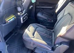 Front passenger seat with black upholstery in a vehicle interior.