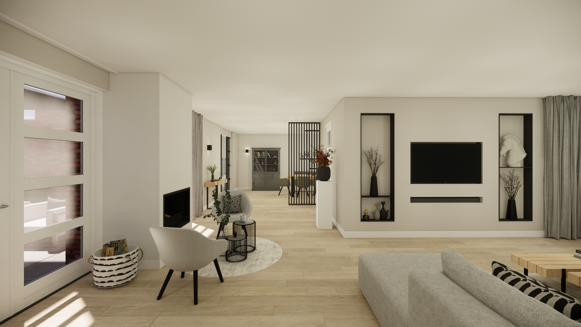 Modern living room with white walls, light wood flooring, large window with curtains, wall-mounted TV, and built-in shelves with decorative items. There is a beige sectional sofa, a cozy armchair, a round area rug, and a small side table with a coffee mug. The space features minimalist decor with plants, vases, and a fireplace.