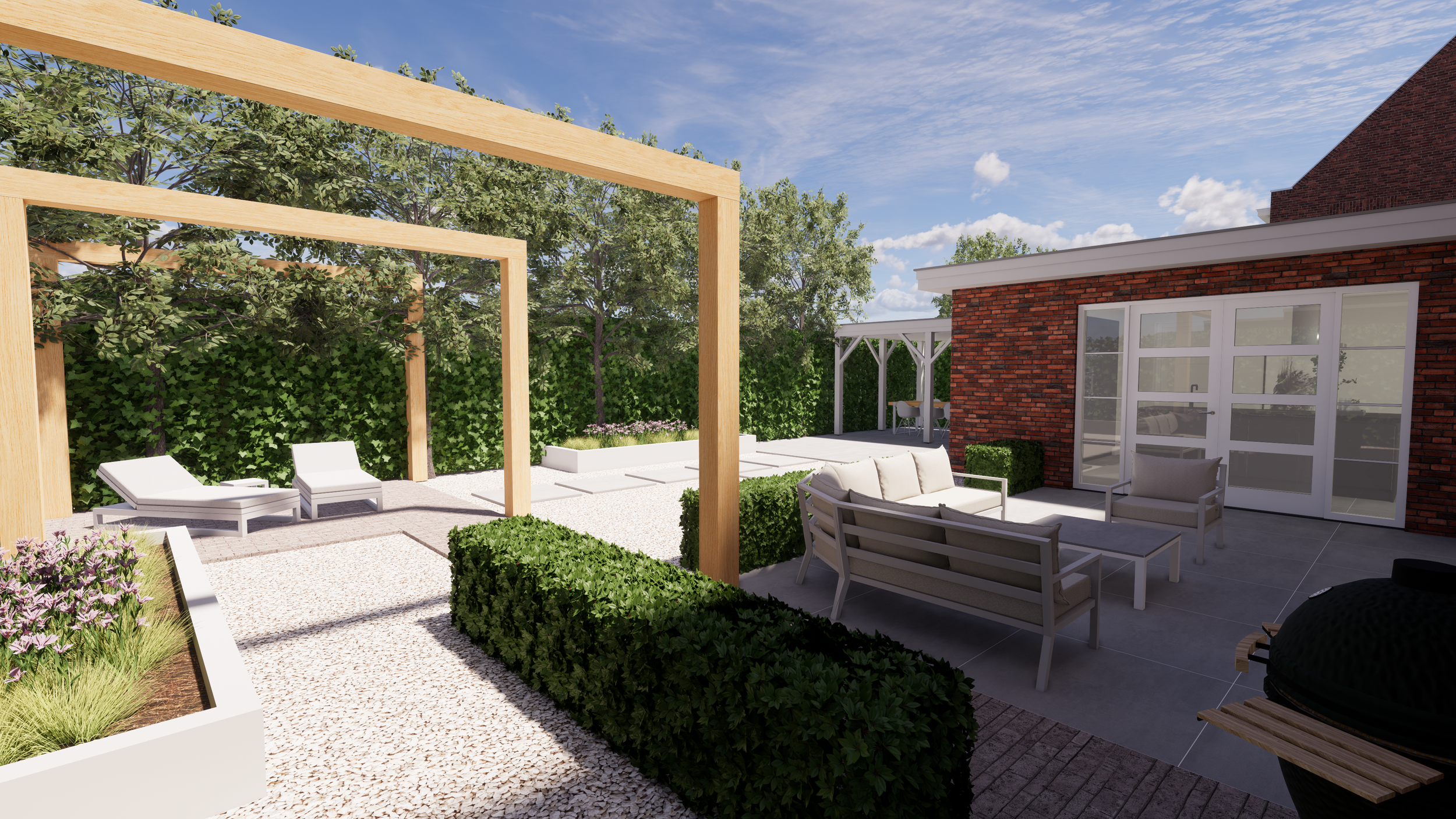 An outdoor patio with modern furniture, including a sofa, chairs, and a table, next to a red brick house with glass doors. The patio is decorated with greenery, benches, and a landscaped garden area with trees and flowers, under a blue sky with scattered clouds.