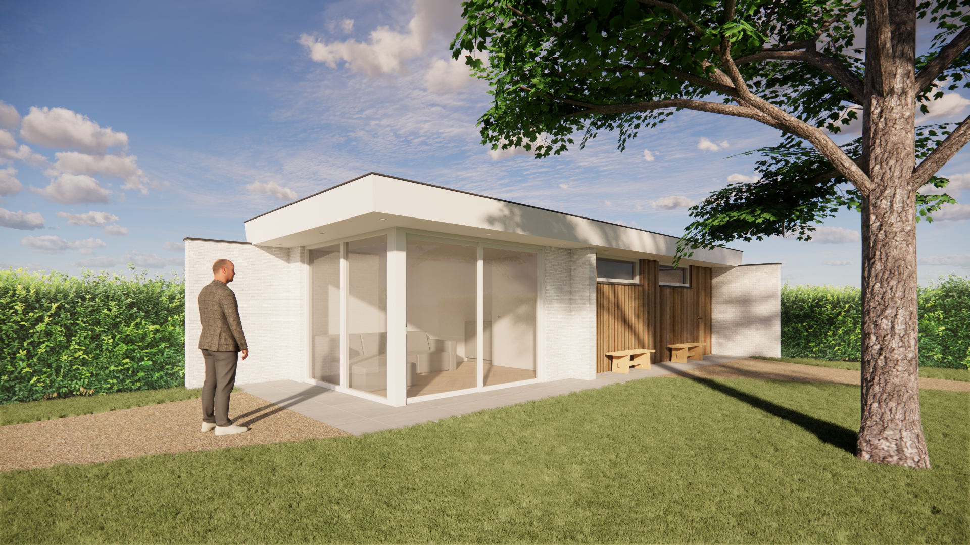 A modern single-story house with large glass windows and a wood-paneled exterior wall, situated on a lawn with a large tree. A man in a brown jacket and gray pants is standing outside, looking at the house. There are benches along the wall and a gravel pathway leading to the house. The sky is partly cloudy with blue sky visible.