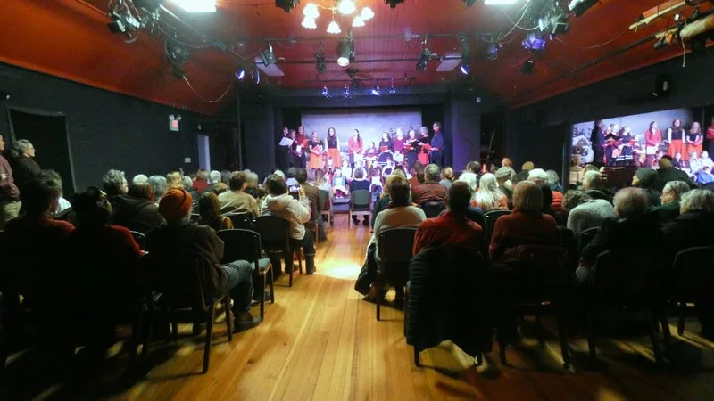 An audience watches children perform on stage at Main Street Arts