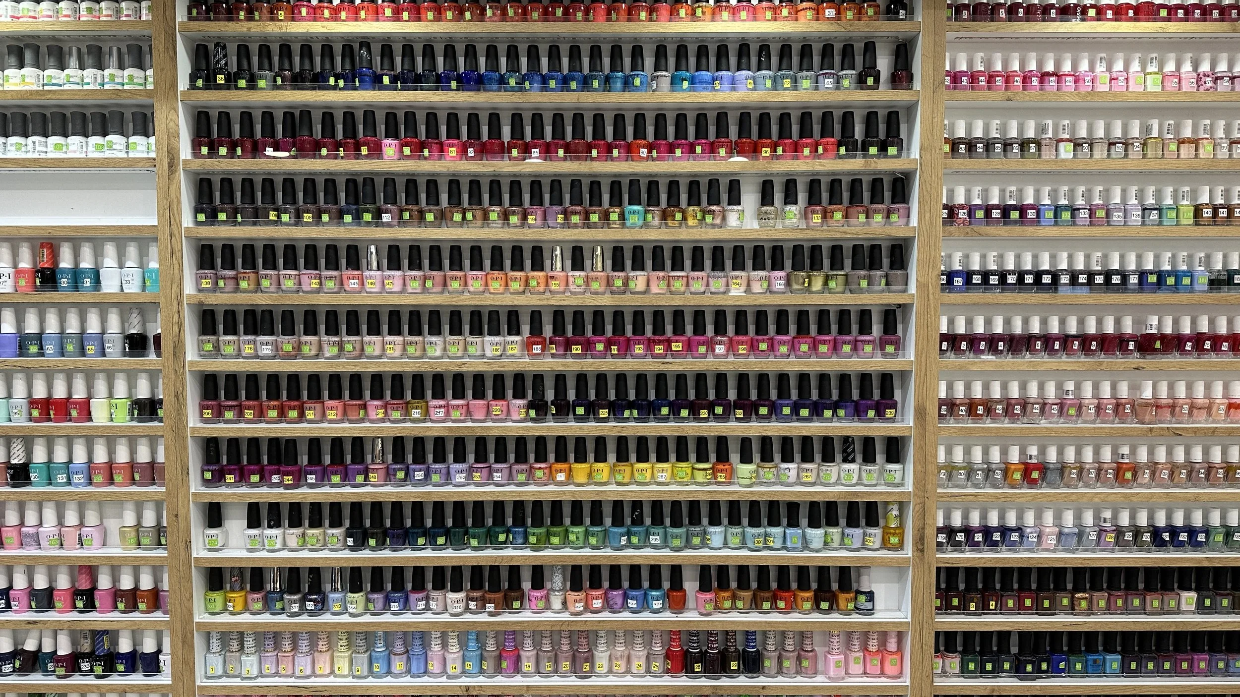 Wall of colorful nail polish options at Cayuga Nail Spa.