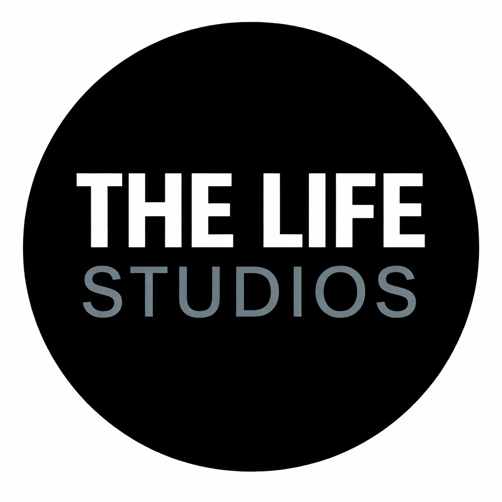 Logo with black background and white and gray text that reads 'The Life Studios'.