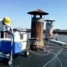 Roof vents on a rooftop with a blue sky background