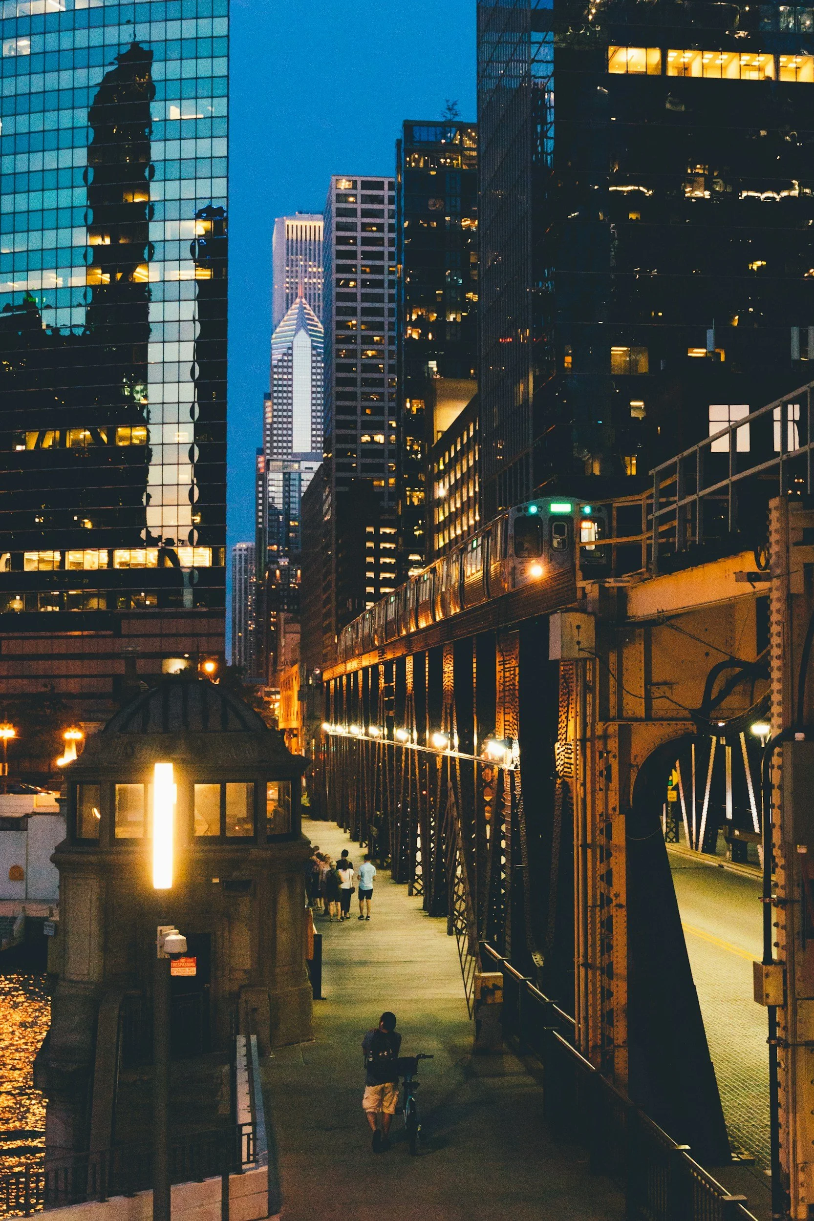 Chicago Loop elevated train with the background of buildings in late evening. Lights glowing.