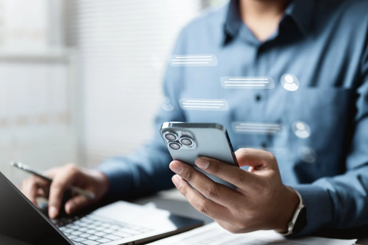 Image of a person working from a computer and phone