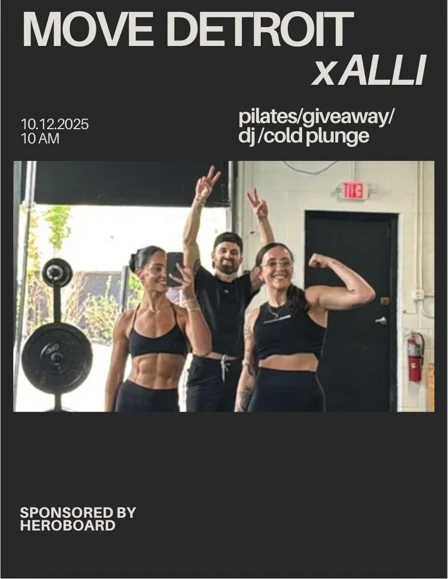 Group of three people in workout attire taking a selfie inside gym after exercising. Woman in black sports bra shows abs, man in black t-shirt raised hand, woman in black sports top flexes arm.