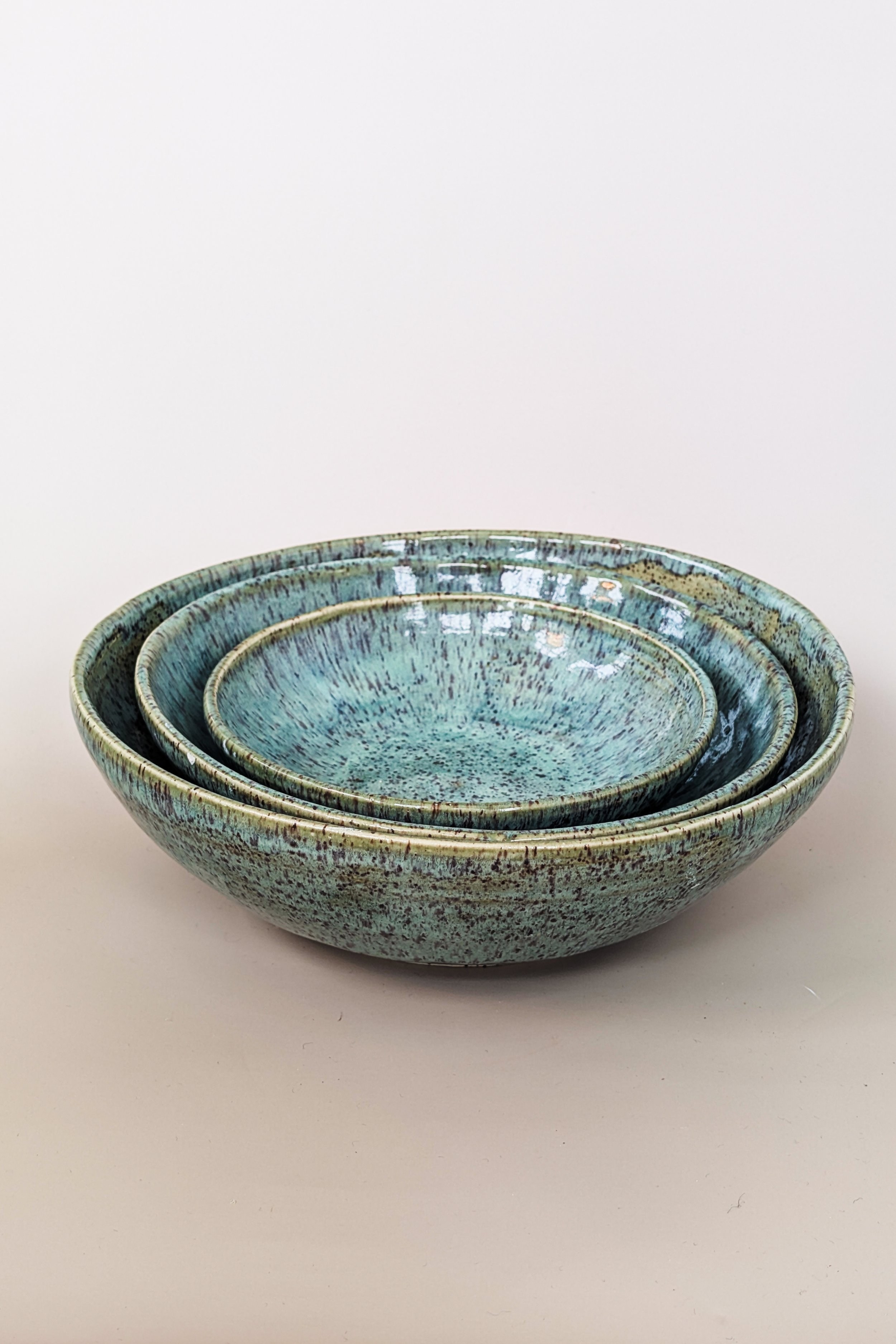 Nesting bowls on speckled clay. 2024.