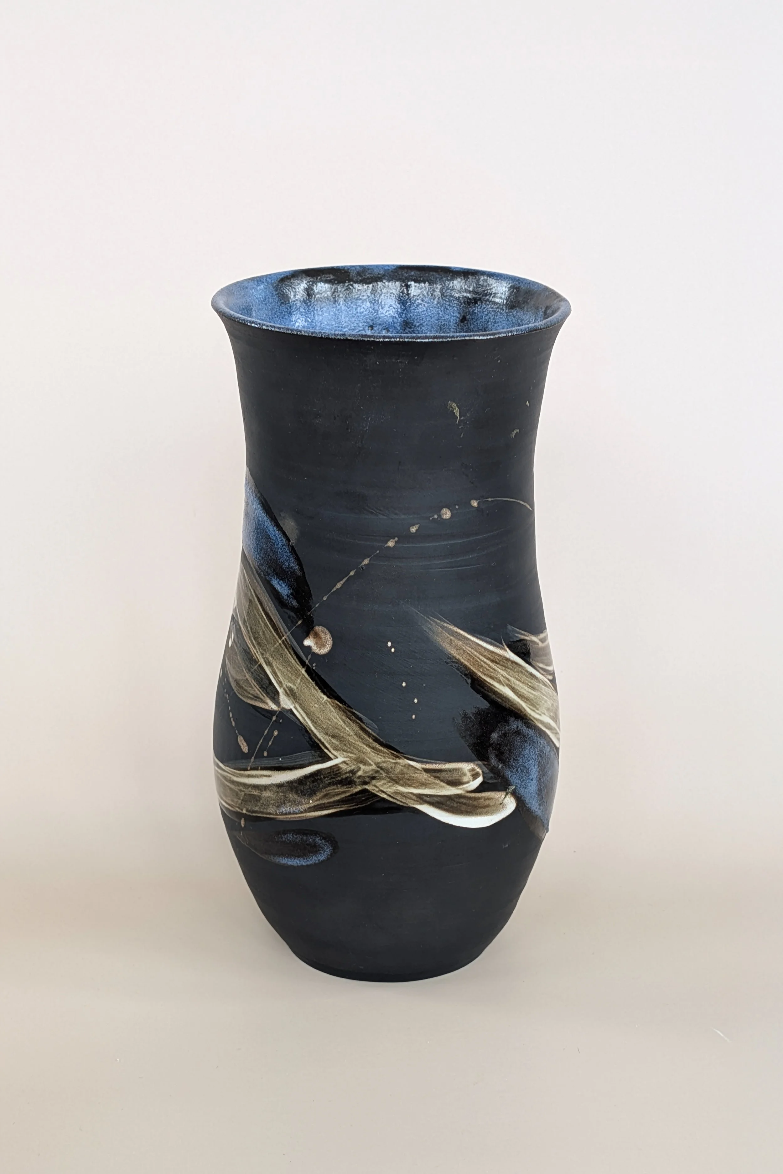 Brush vase on dark clay. 2025.