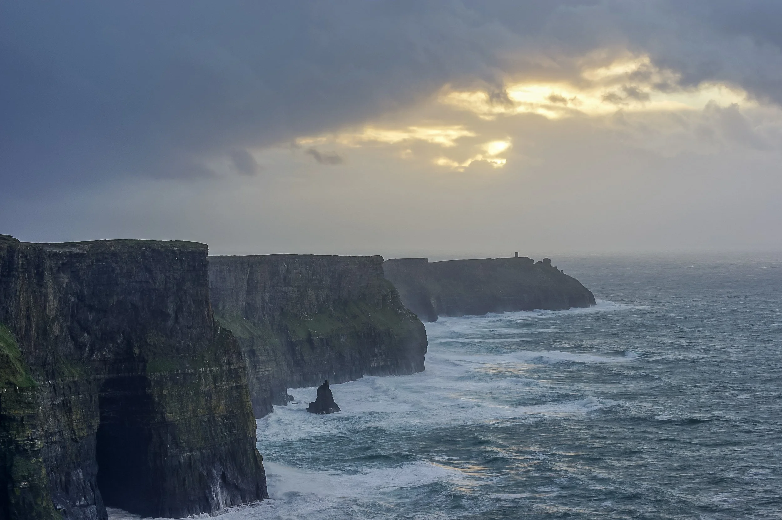 Dramatic Cliffs of Moher on Ireland’s west coast overlooking the Atlantic Ocean beneath stormy clouds