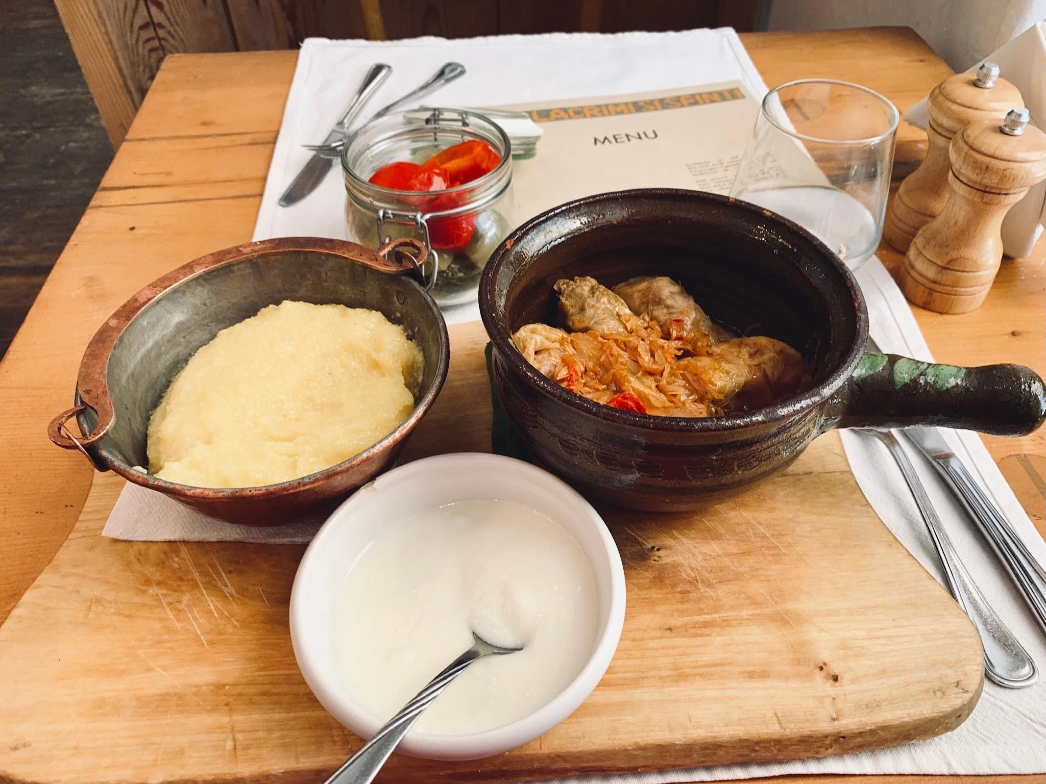 Sarmale at Lacrimi și Sfinți in Bucharest, featuring stuffed cabbage rolls served with polenta and sour cream