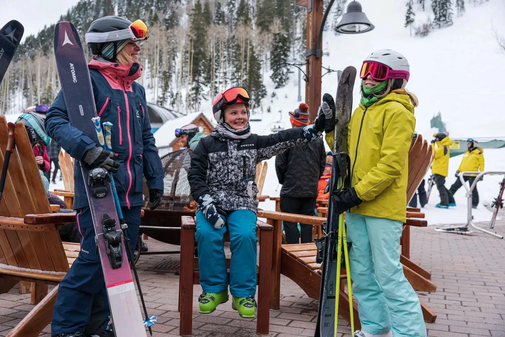 Family skiers preparing at a ski resort base area