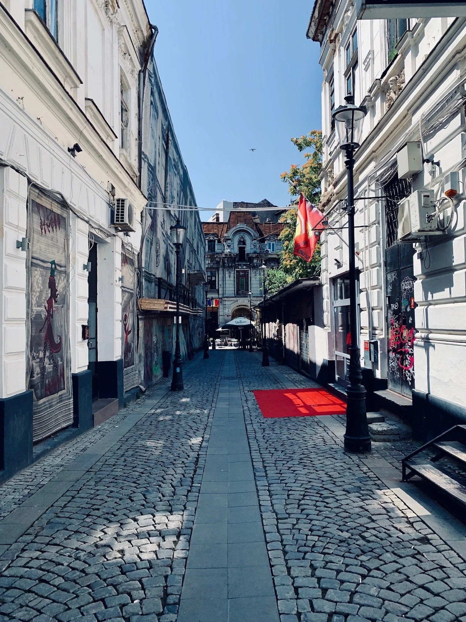 Historic cobblestone street in Old Town Bucharest, Romania, showcasing preserved architecture and urban character