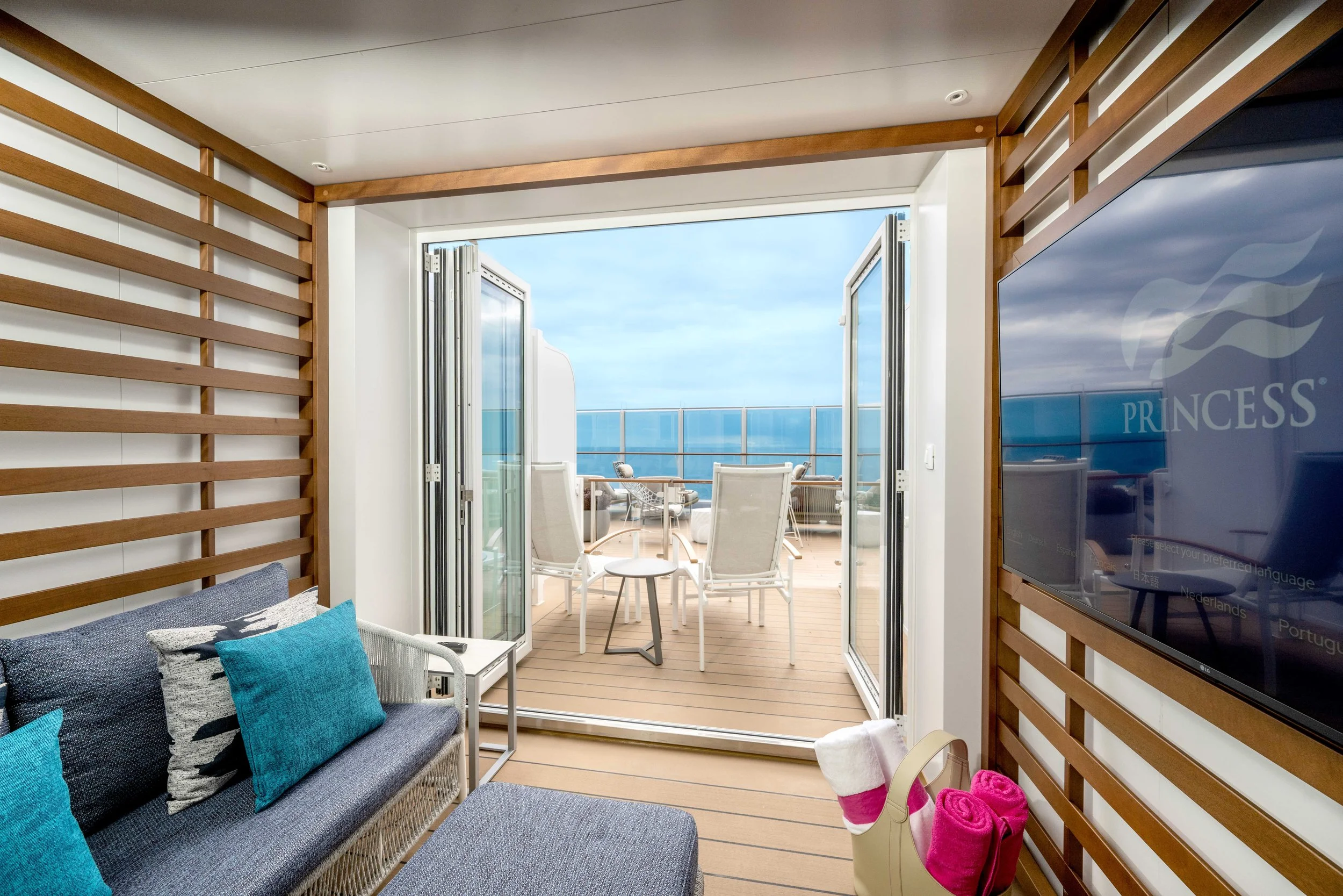 Princess Cruises mini-suite cabin featuring a sitting area and private balcony with ocean views