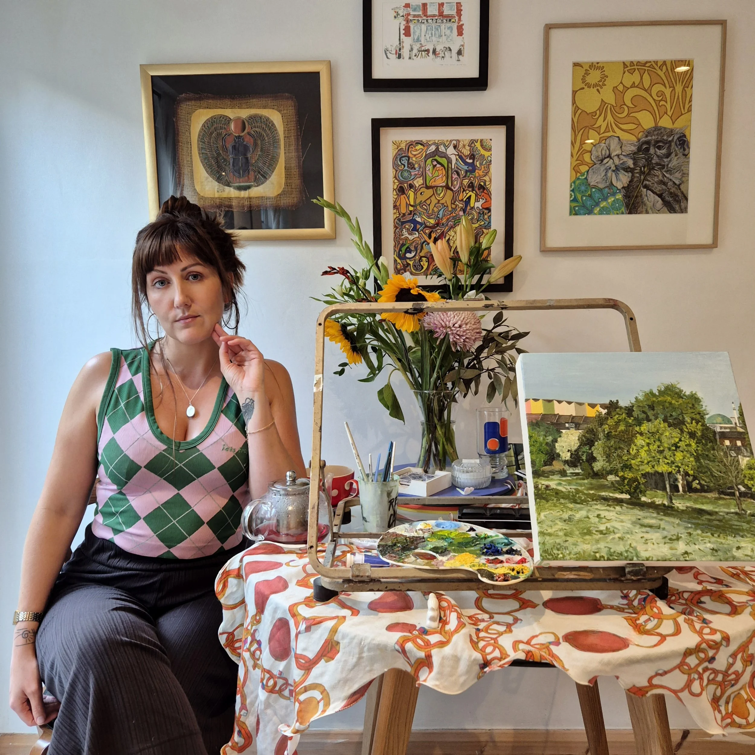 The artist next to their easel