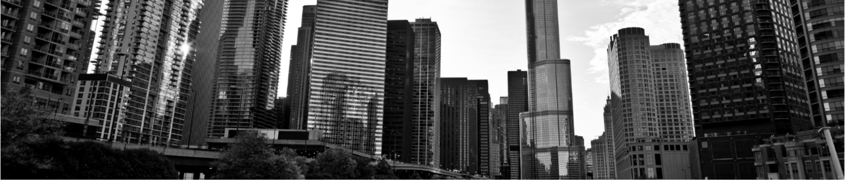 Black and white photo of a city skyline with tall skyscrapers and buildings.