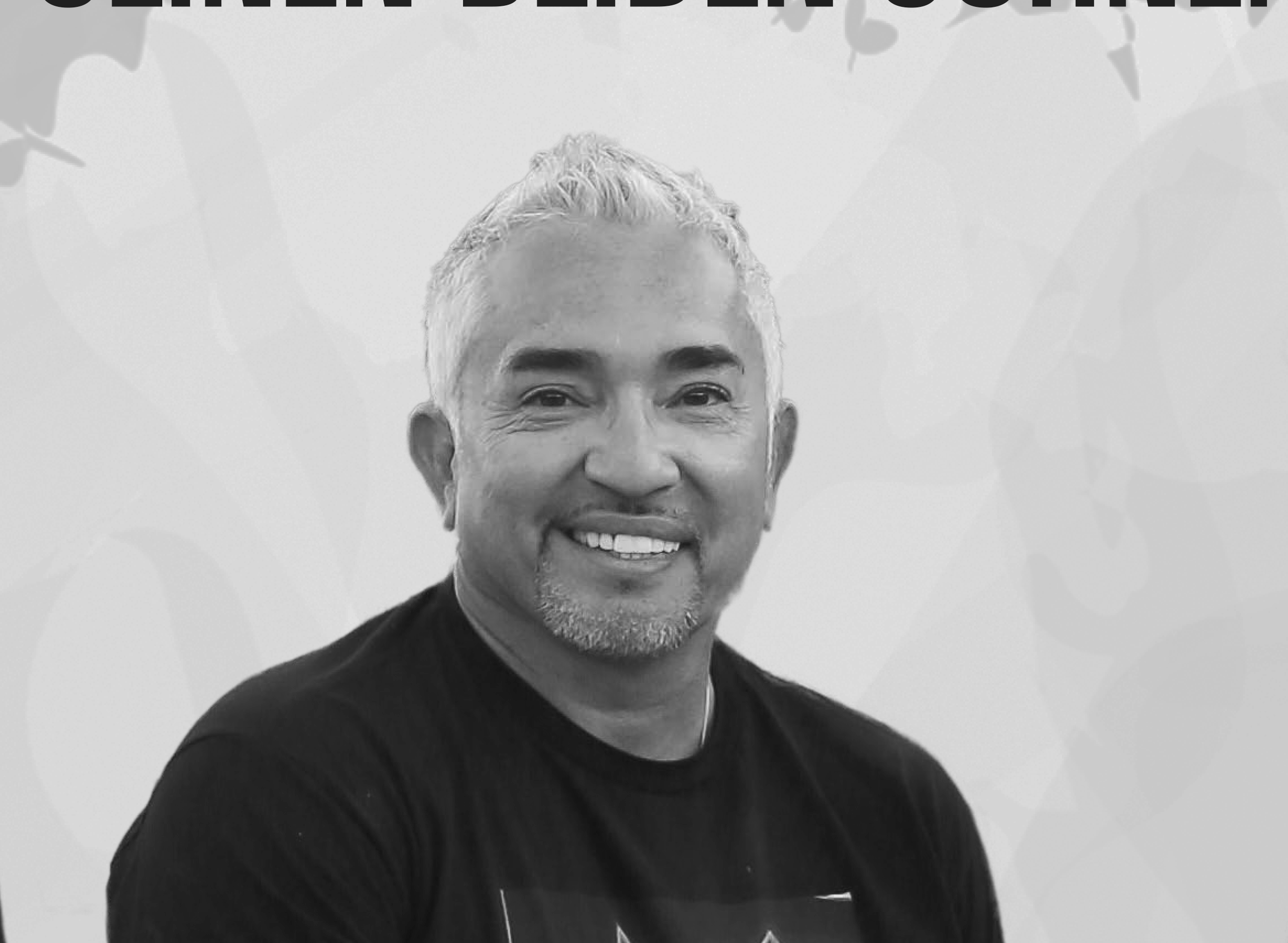 A smiling man with short, gray hair and a goatee, wearing a black T-shirt, posed in front of a light background with faint world map outlines.