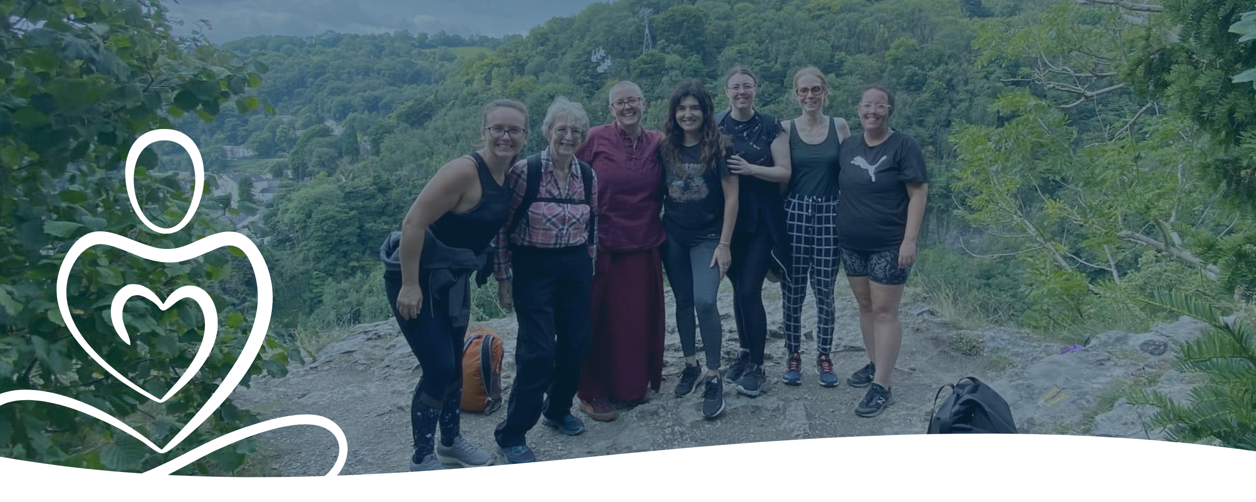 A picture of a group of happy participants on a retreat in the countryside