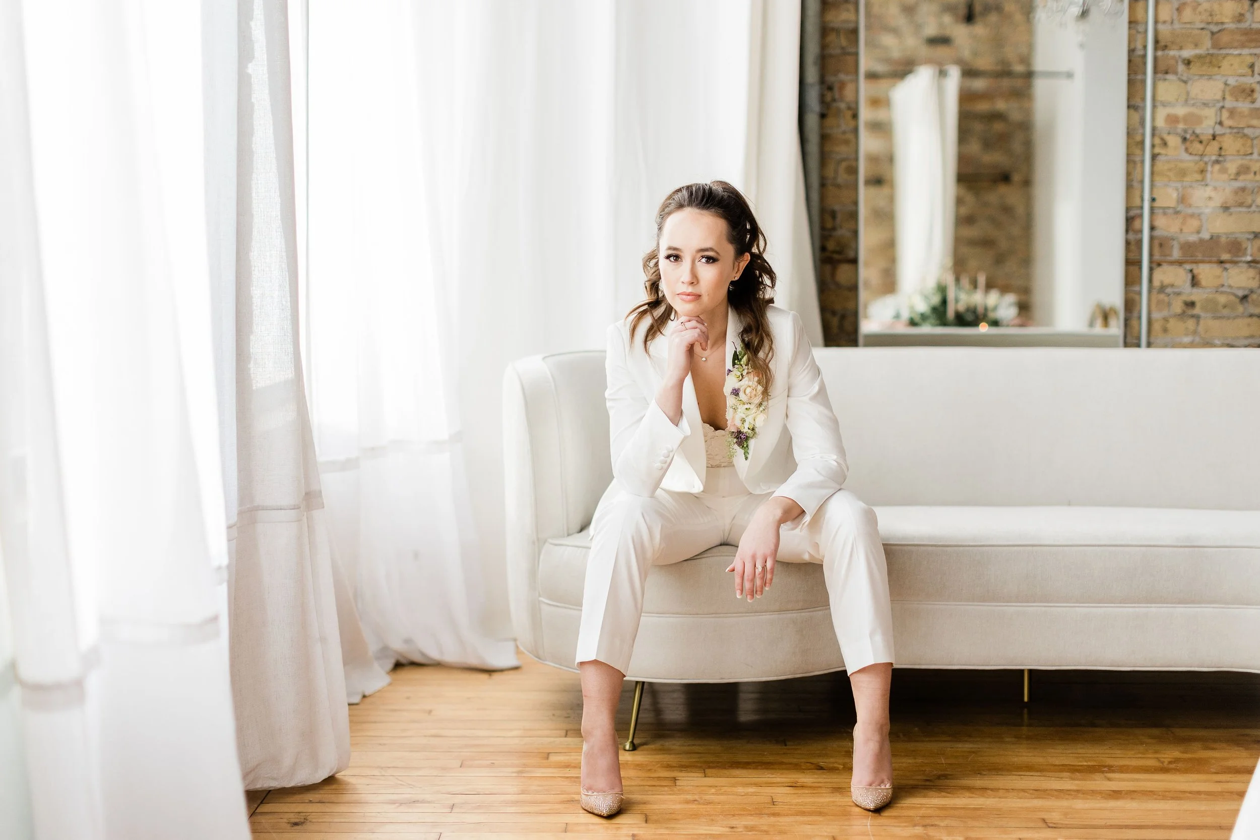 Chicago wedding planner in white suite with floral lapel