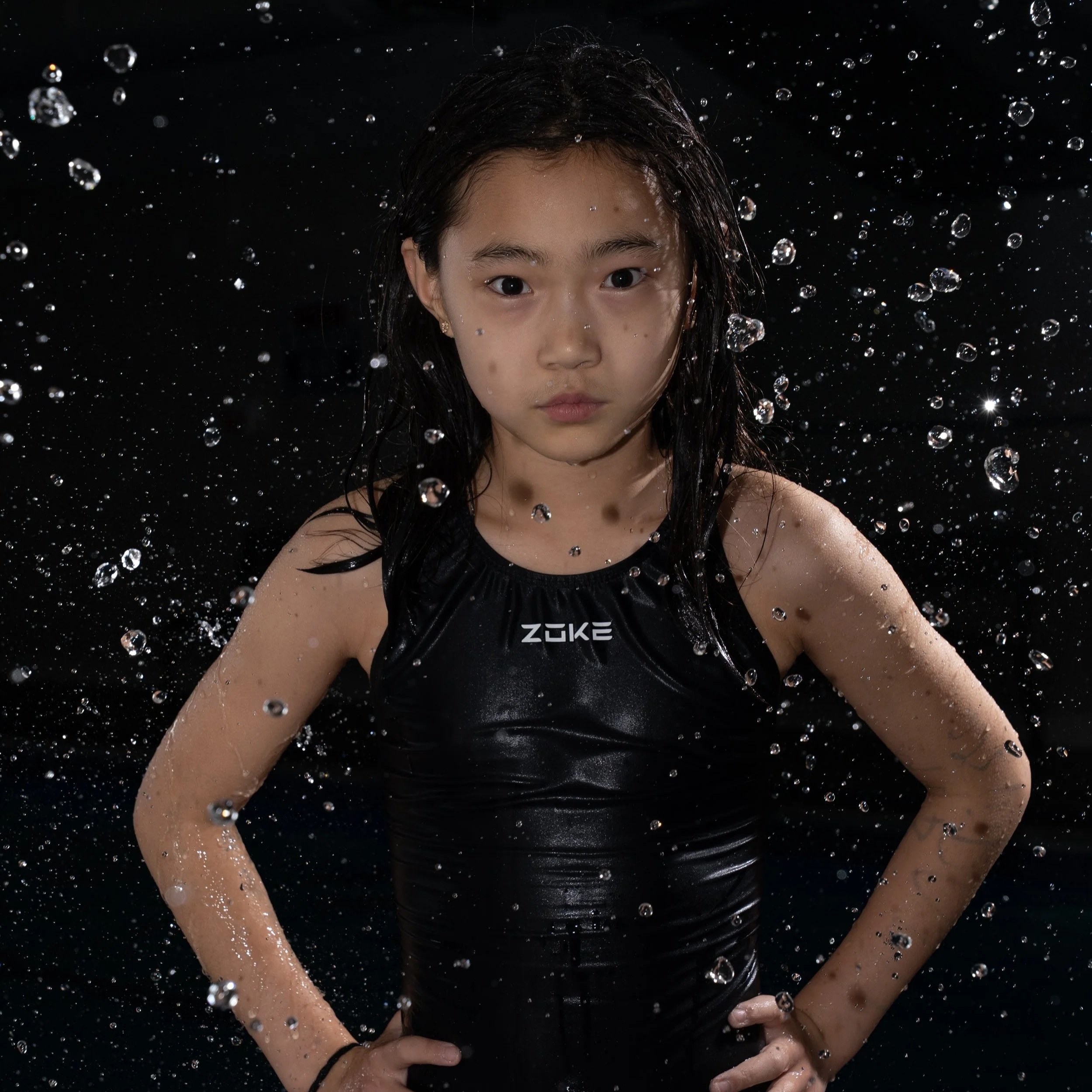 Athlete captured in controlled motion, water suspended midair