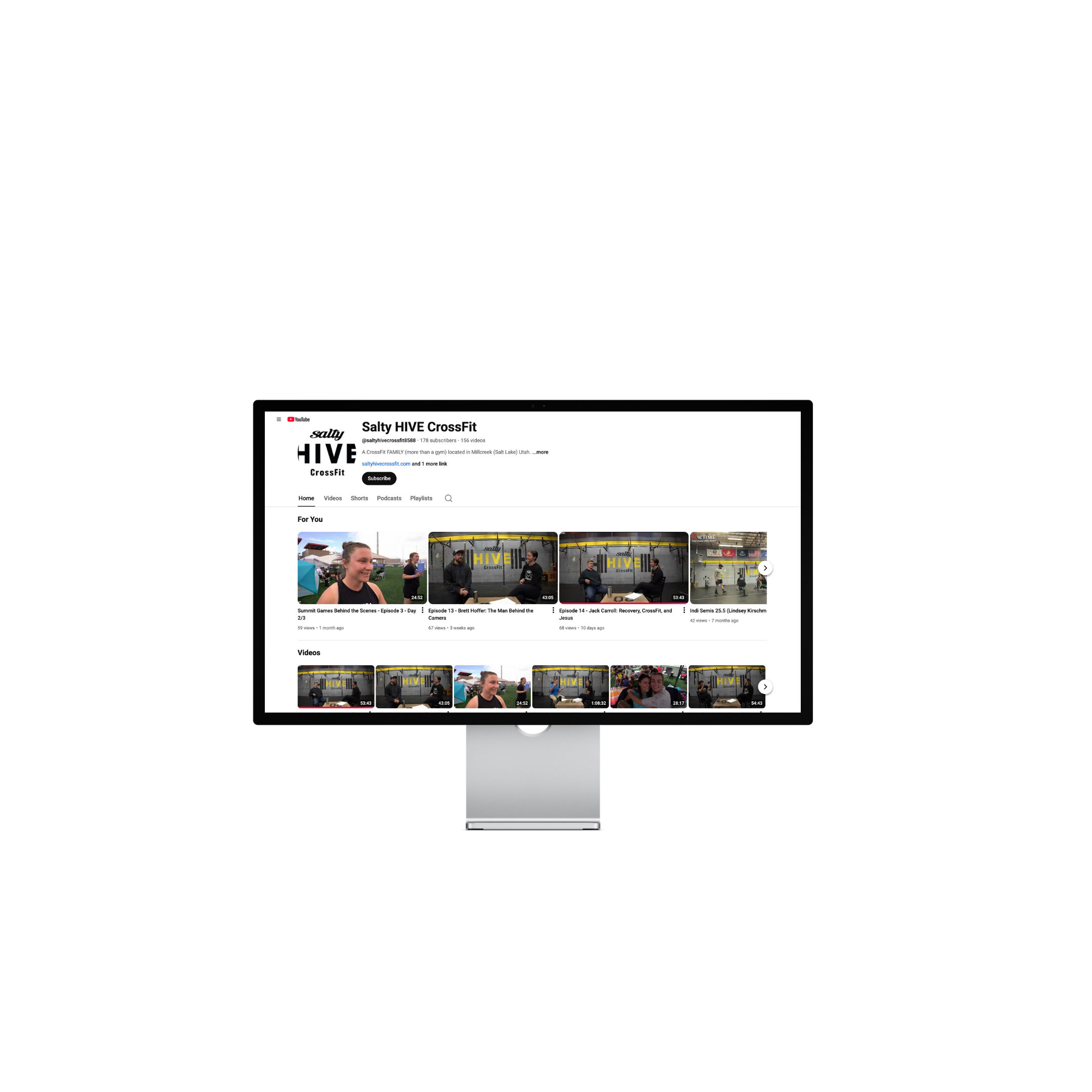 A computer monitor displaying a YouTube channel page for Salty HIVE CrossFit, featuring videos of CrossFit activities and episodes, with a black background.