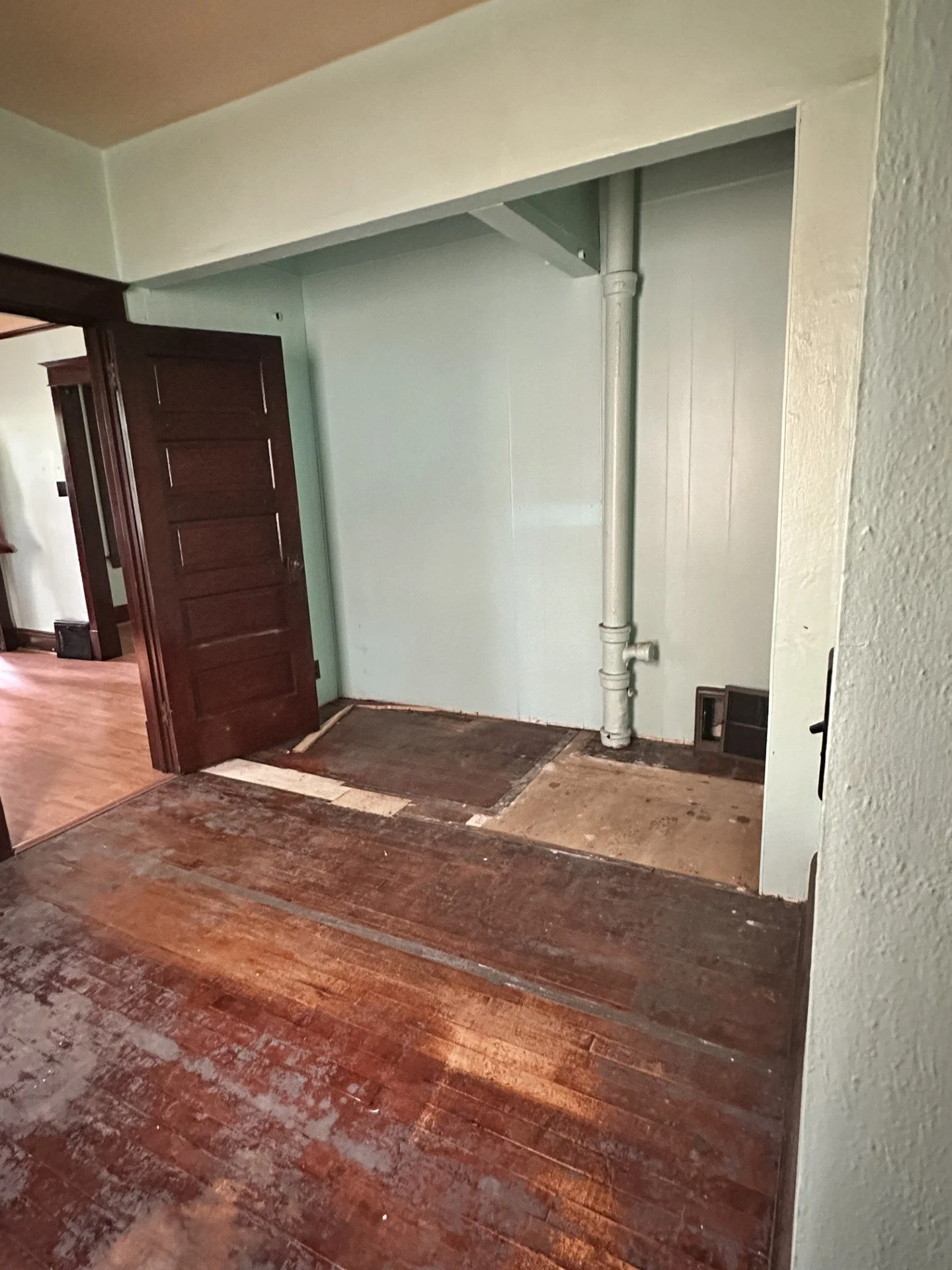 *New flooring 
*New door 
*Paint walls 
*Box in the pipes and create a wall to have the laundry room and closet here (original laundry room was in the porch) 