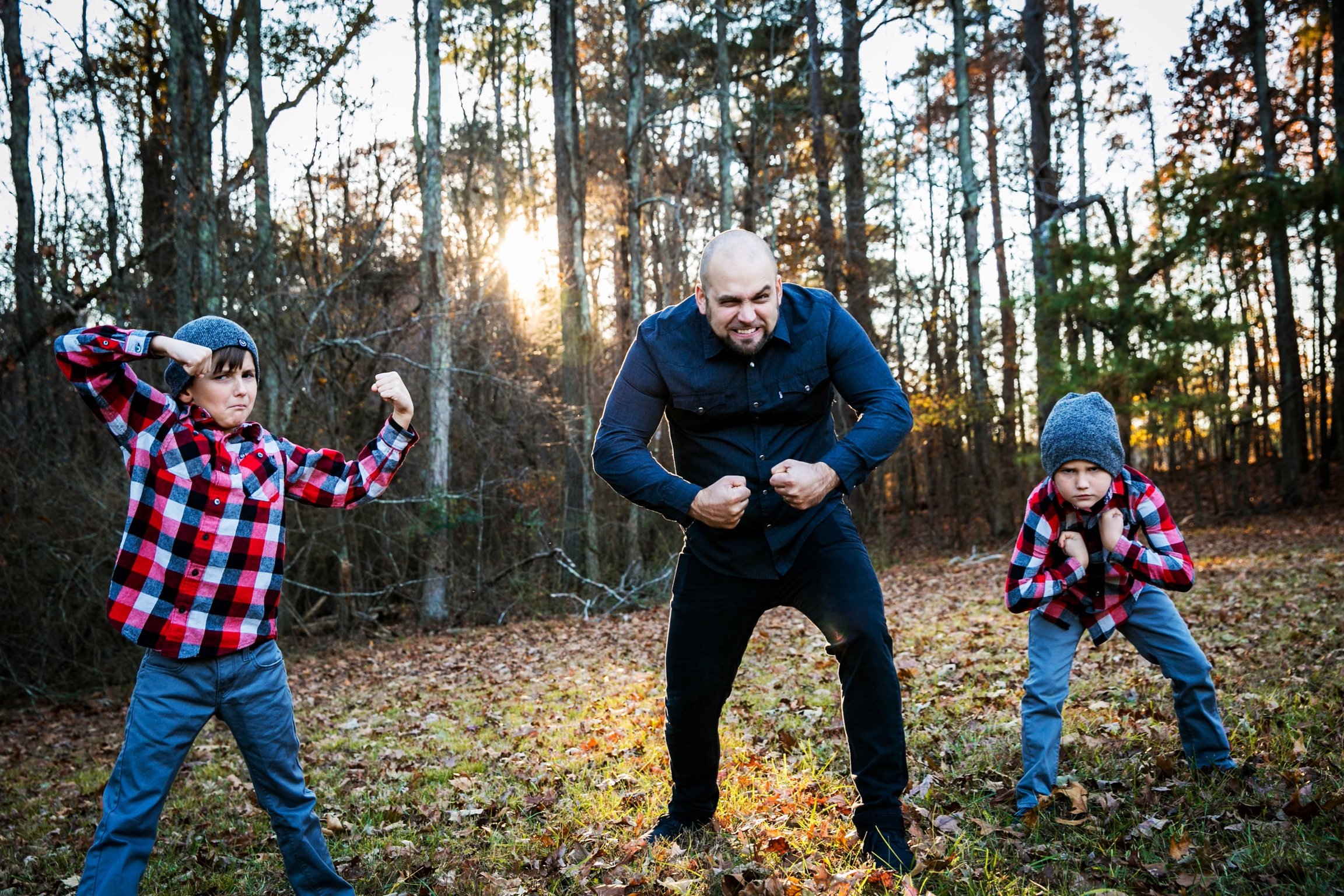 Jake Collier a man and his sons flexing their muscles