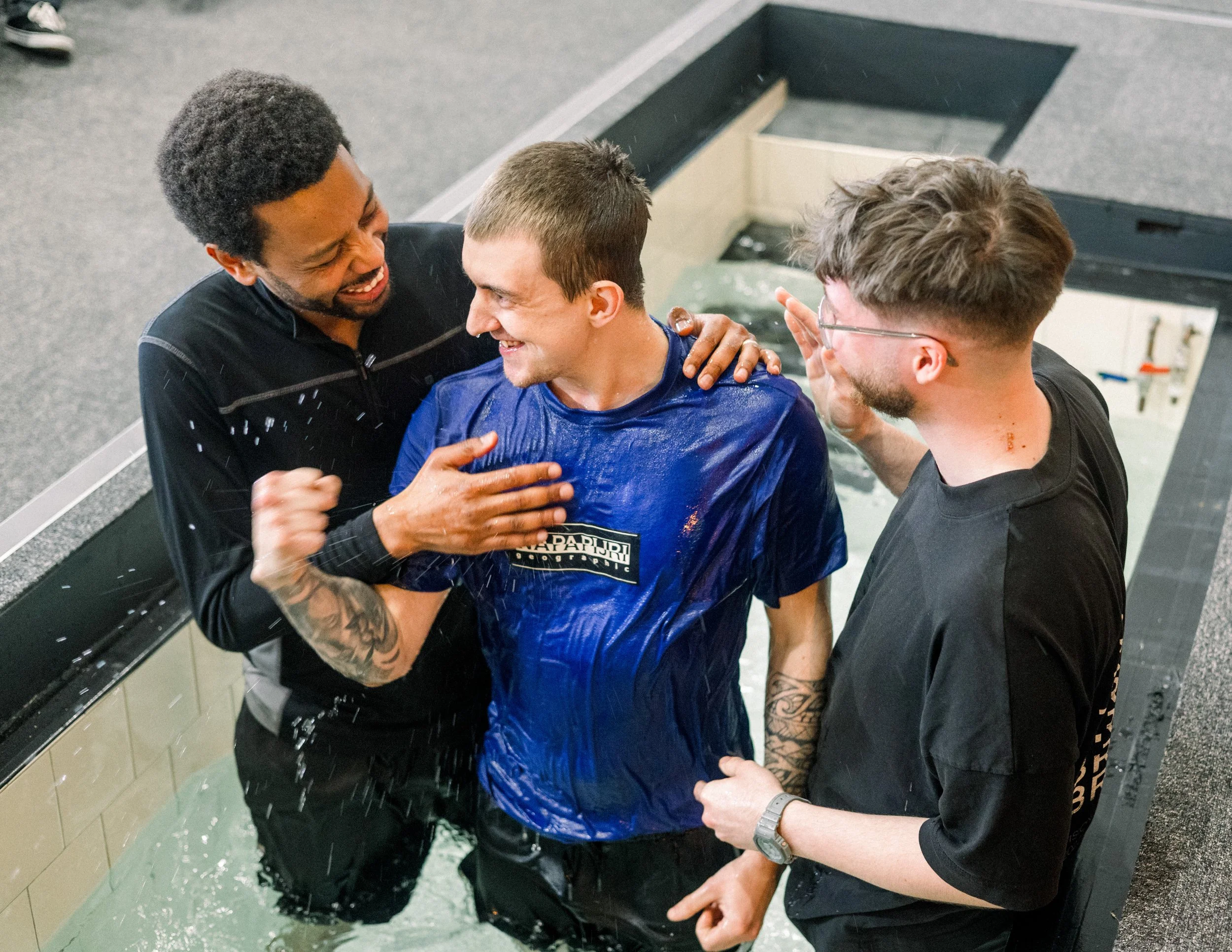 Photo of young adult coming up from the waters of baptism