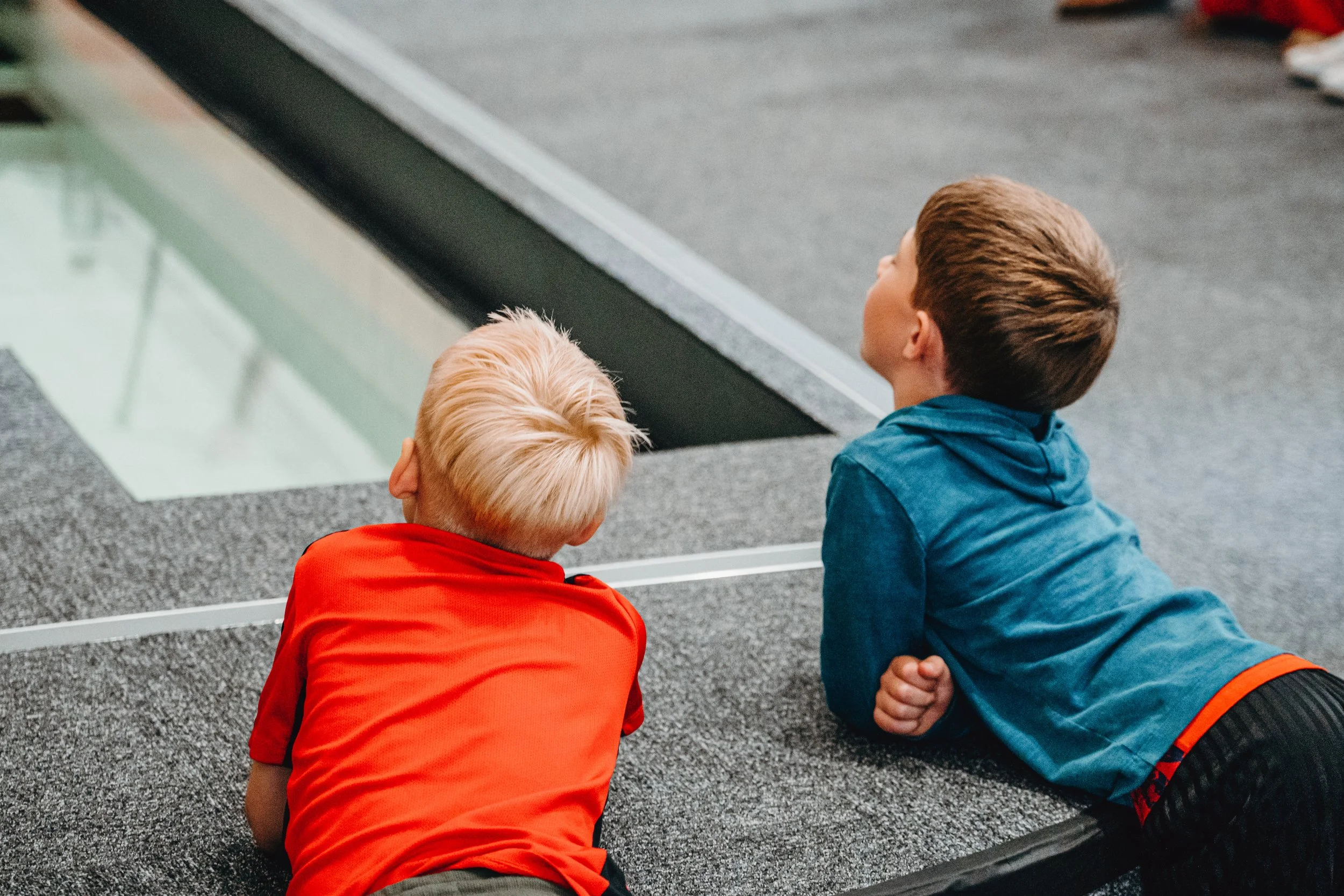 Young boys watching from the edge of the baptismal tank