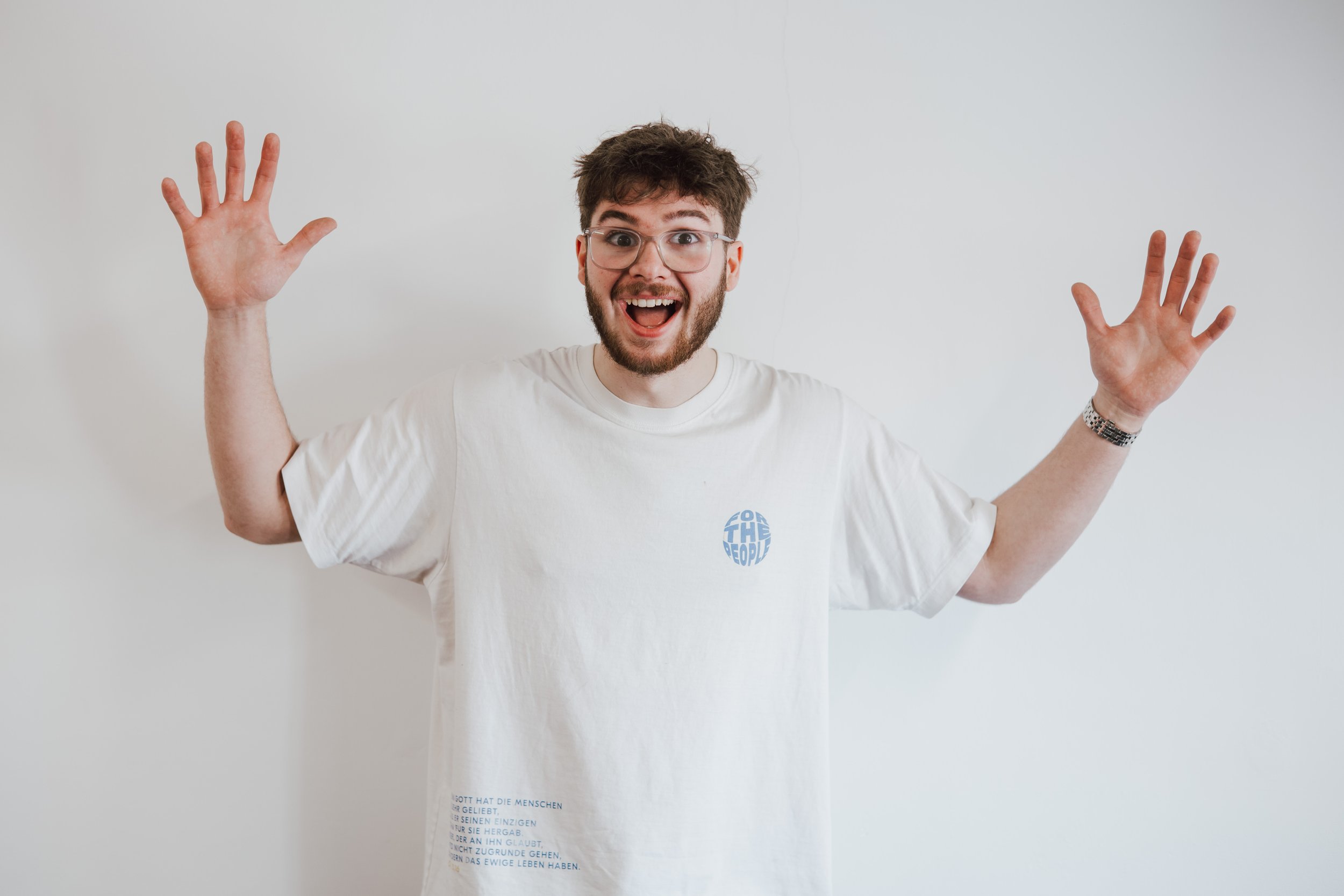 Ben Ayling pulling an excited face with his arms raised in the air.