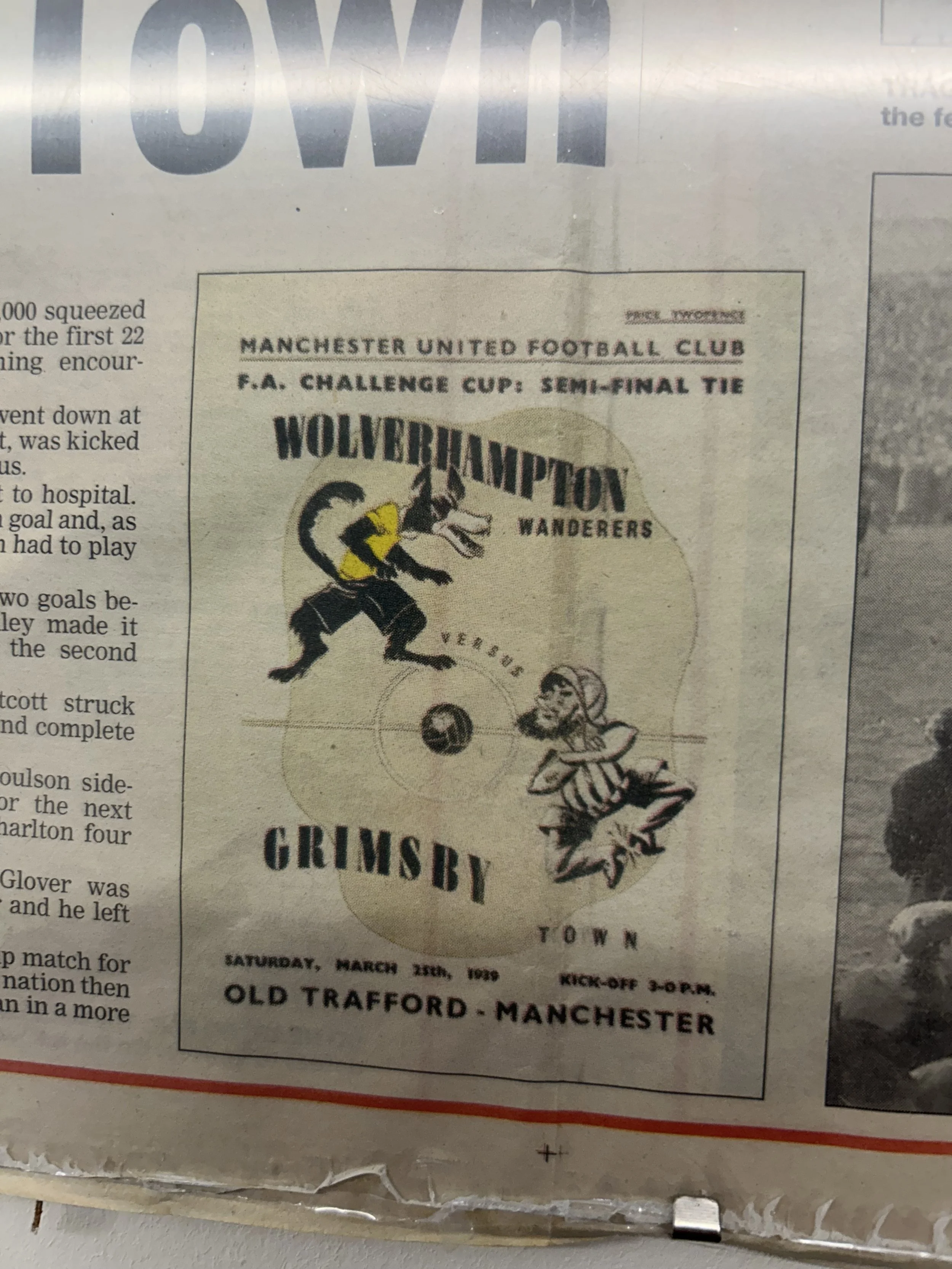 A vintage poster advertising a football match between Wolverhampton Wanderers and Grimsby Town, held on Saturday, March 25th, 1950, at Old Trafford in Manchester, with a kick-off time of 3:00 PM.