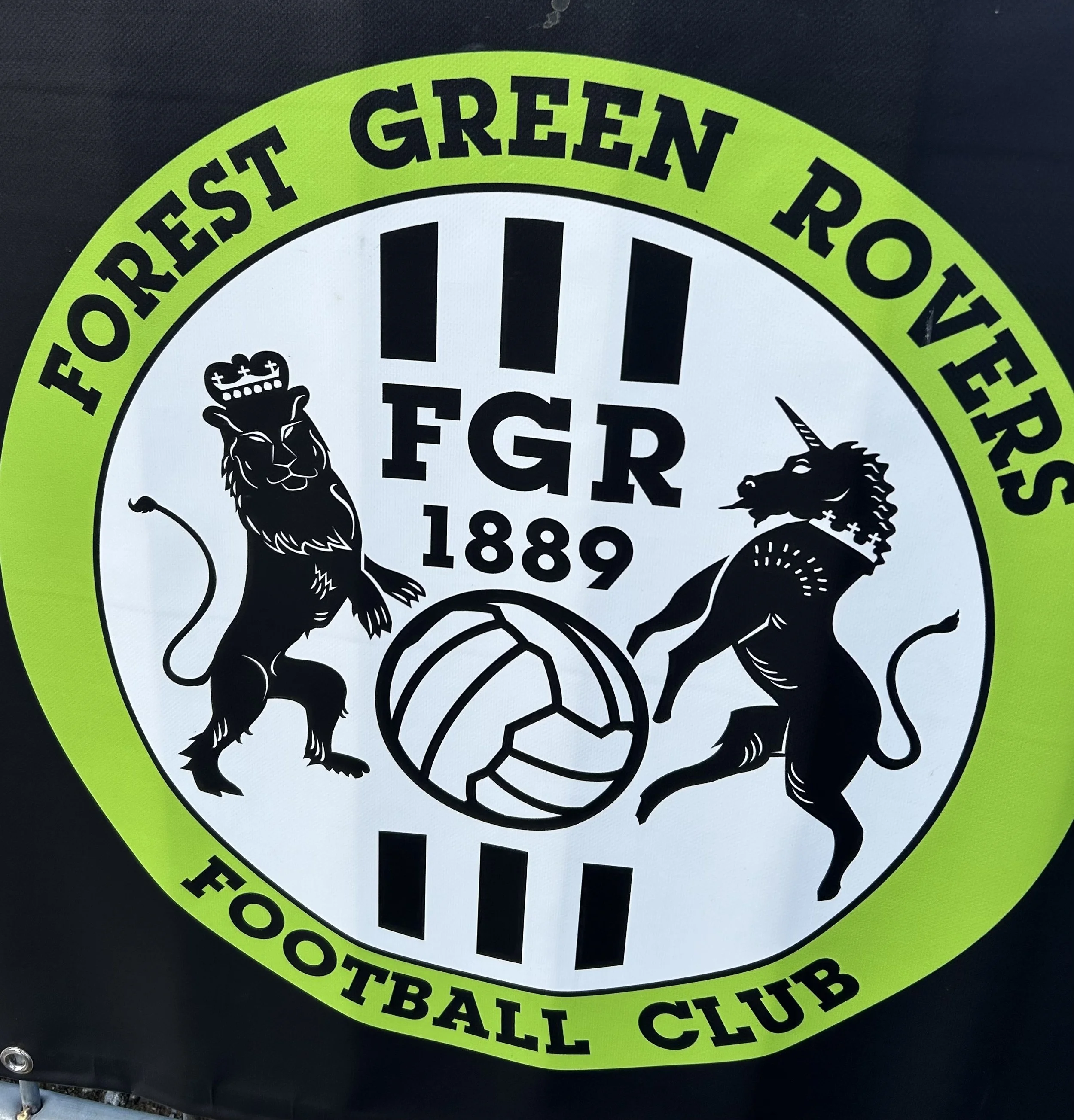 Logo of Forres Green Rovers football club featuring two heraldic lions, one with a crown and the other with a unicorn horn, with a football in the center and text including 'FGR 1889' and the club's name and establishment date.