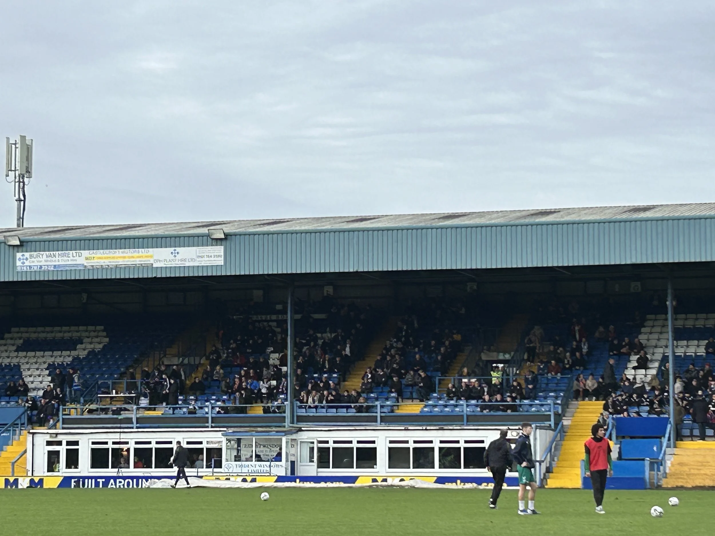 Football stadium with spectators in the stands and players on the field