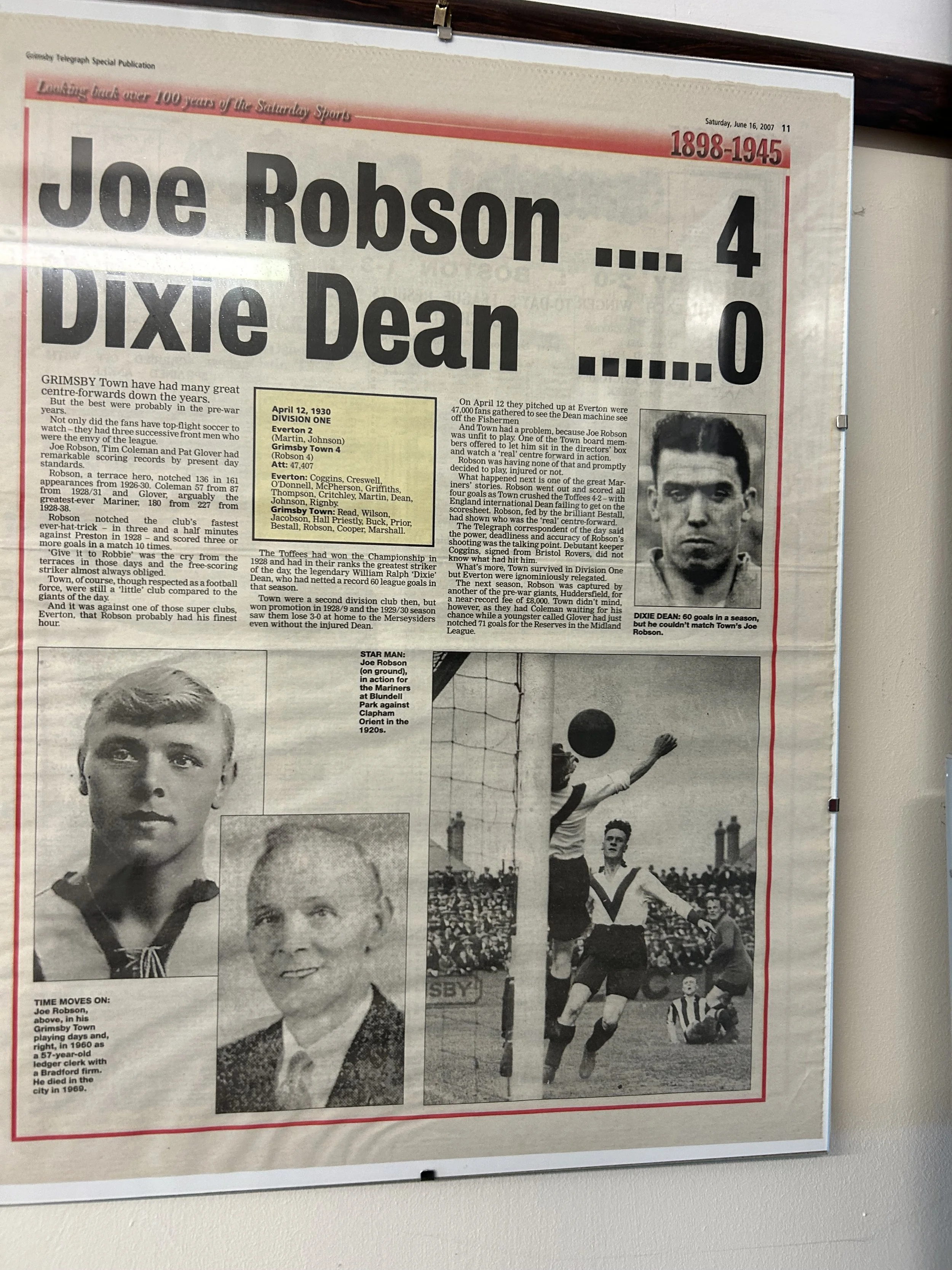 A newspaper page featuring a sports story about Joe Robson and Dixie Dean. It includes a black-and-white photograph of Joe Robson, a yearbook-style portrait of Dixie Dean, and a vintage photograph of a soccer match with players jumping to Head a ball