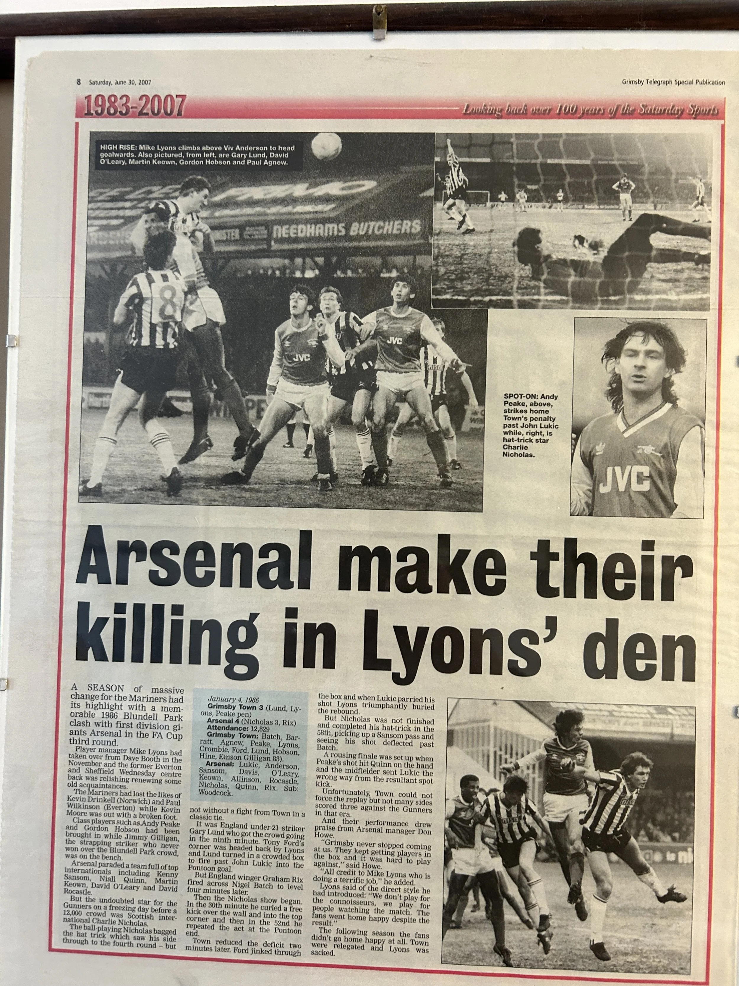 A newspaper page featuring soccer photos and an article titled "Arsenal make their killing in Lyons' den" about a match on January 4, 1986, between Arsenal and Lyon's team. It includes photos of players and moments from the game, with a focus on Andy