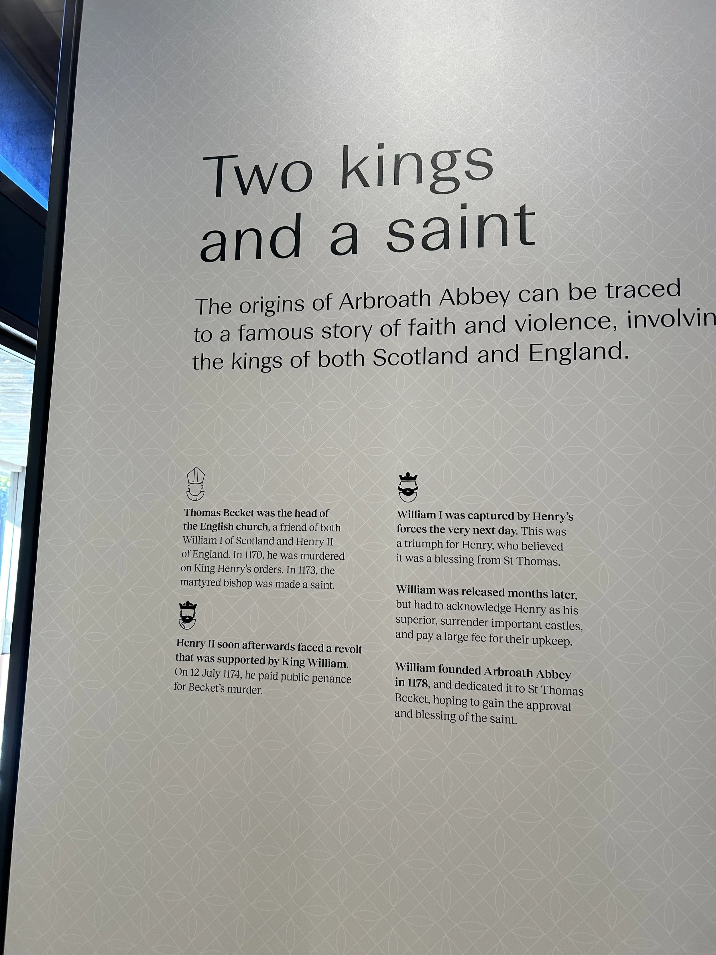 Educational display titled 'Two kings and a saint' with information about the history of Arbroath Abbey, including figures Thomas Becket, William I, Henry II, and King William, with icons representing historical figures.